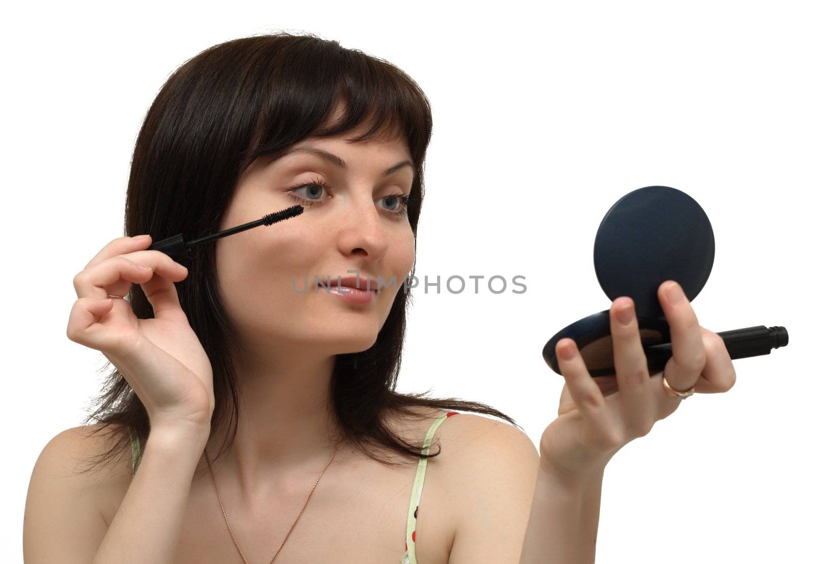 Young woman making up, isolated on white background