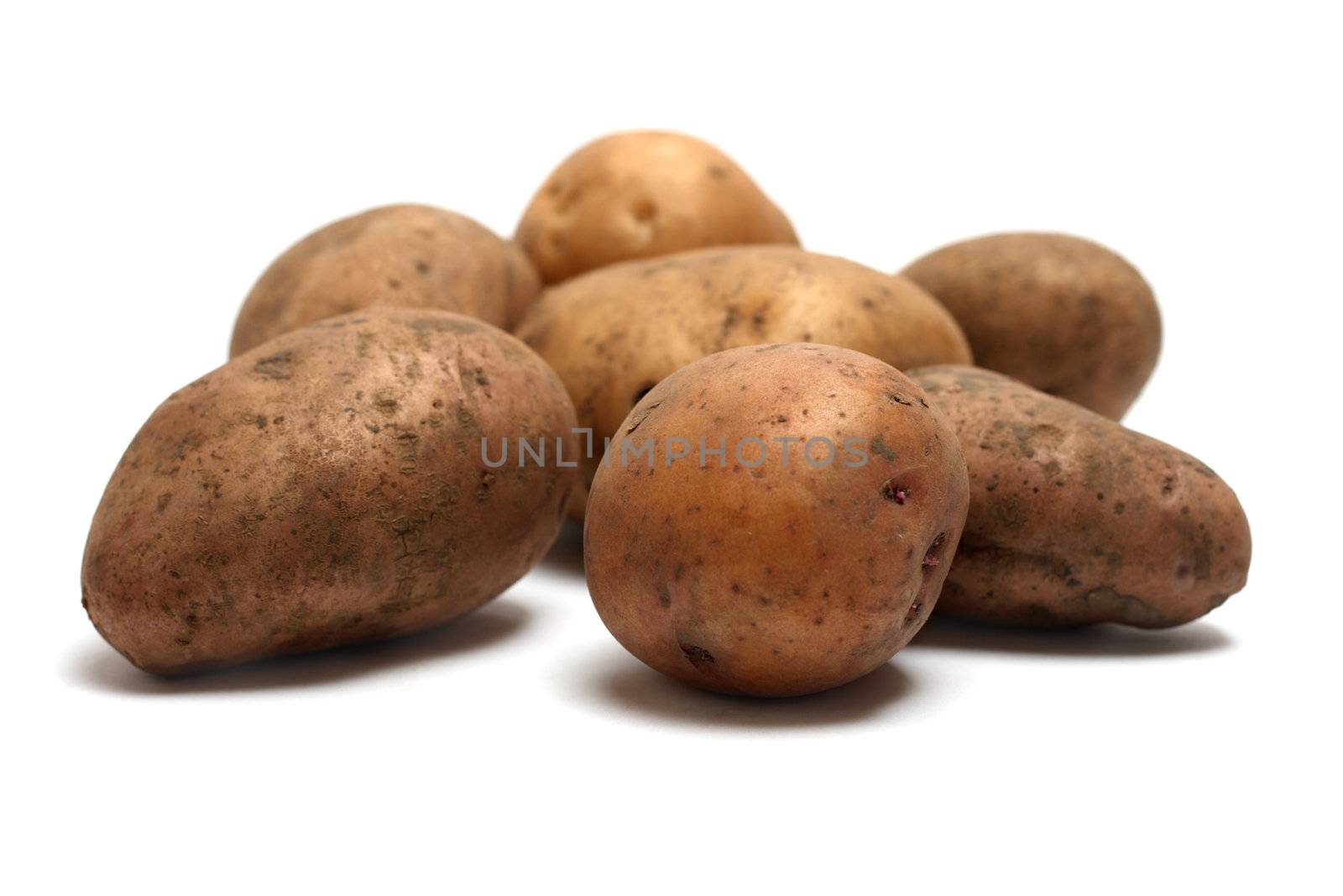 Pile of organic raw potatoes by Gdolgikh