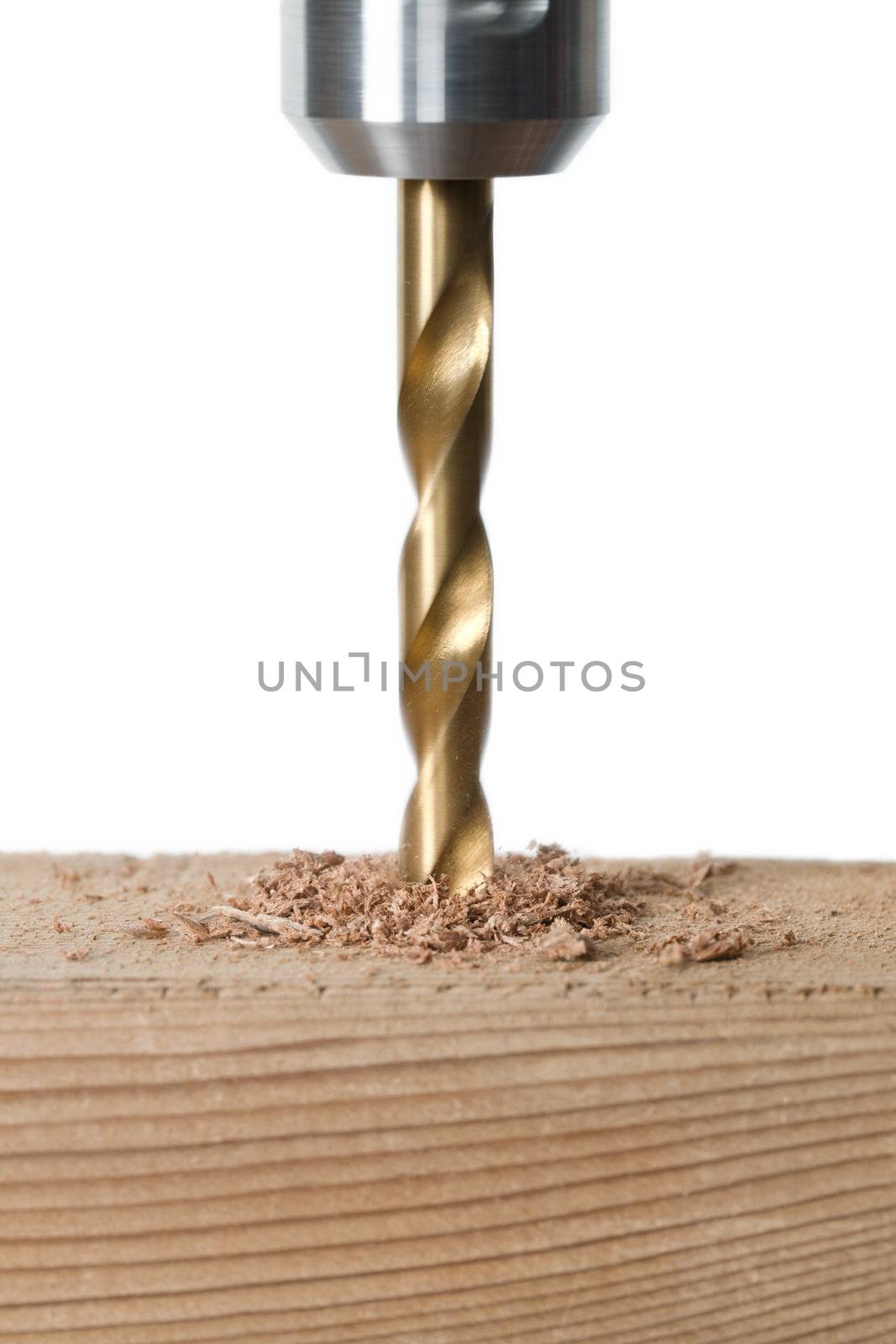 Close-up image of a drilling hole on a wooden plank isolated on a white background