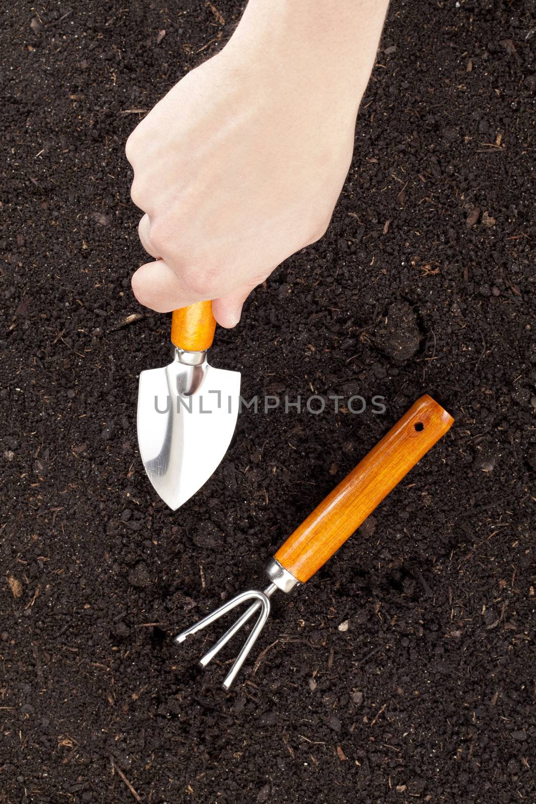 Close up image of digging soil using shovel