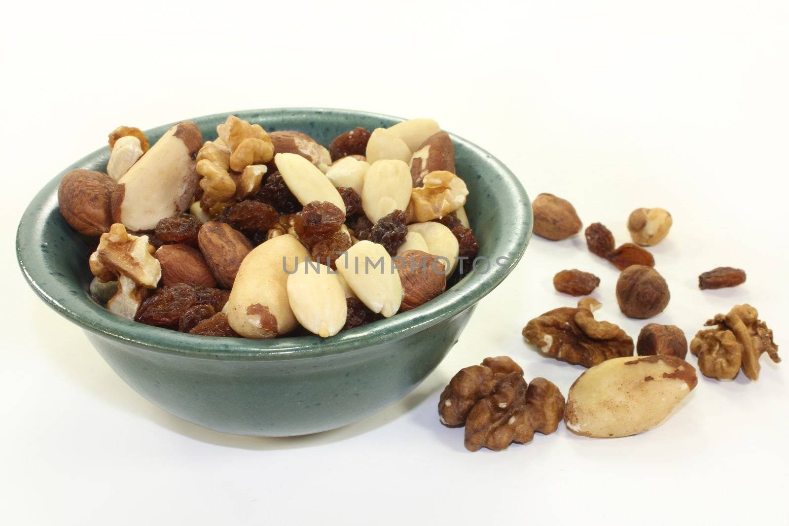 various nuts and raisins on a white background