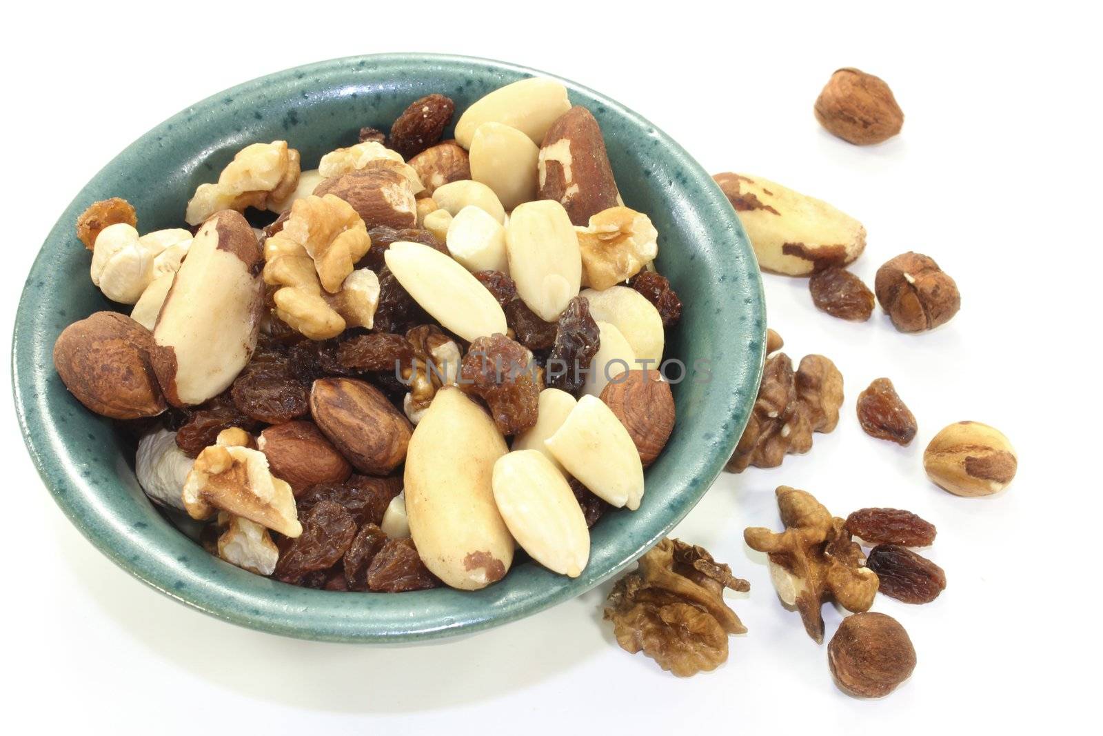 various nuts and raisins on a white background