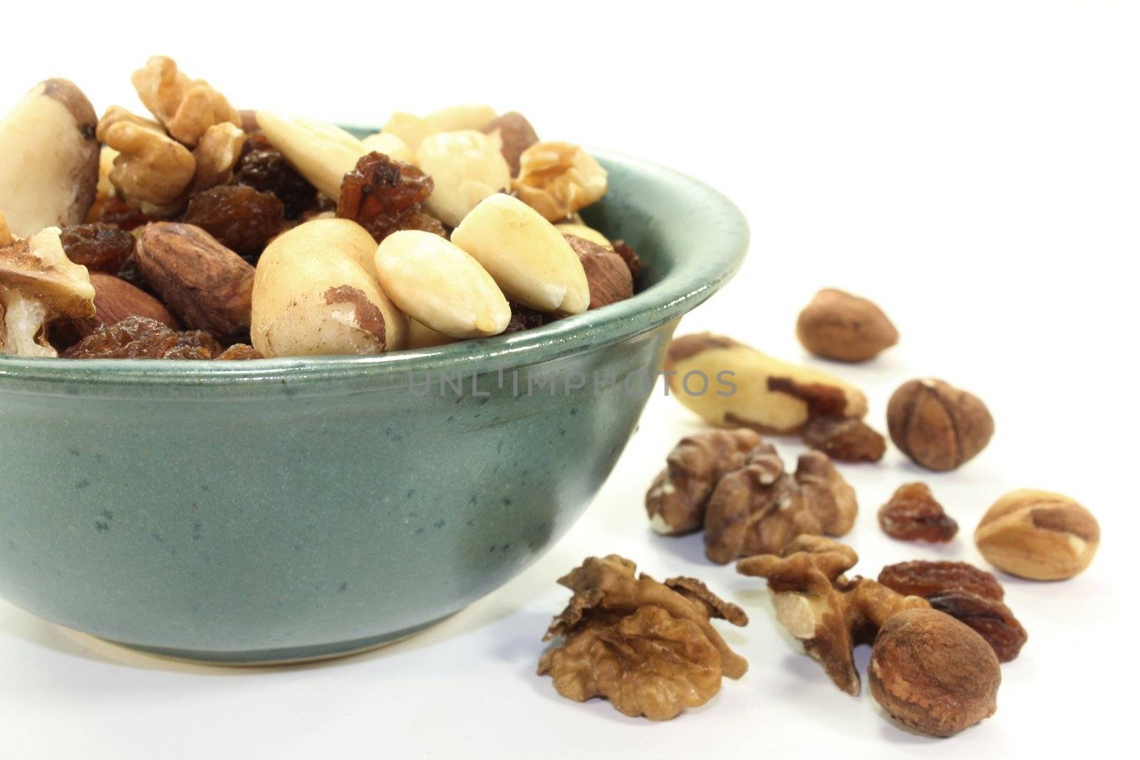 various nuts and raisins on a white background