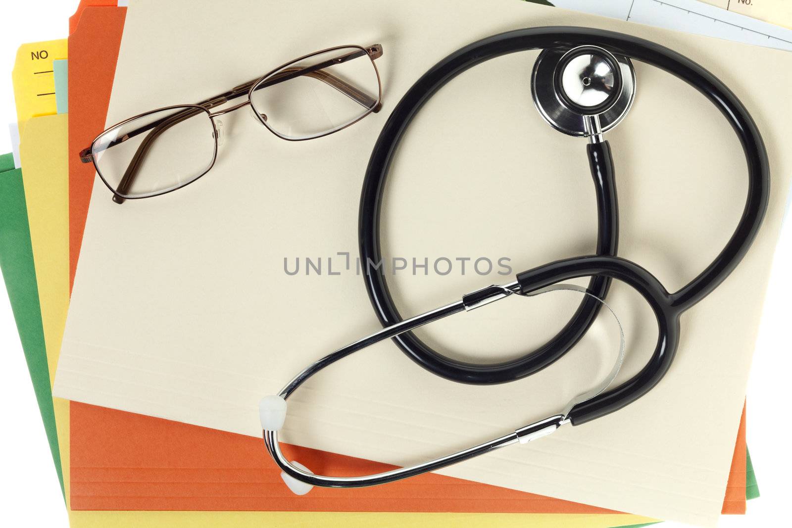 Close-up shot of a stethoscope with medical reports and spectacles.