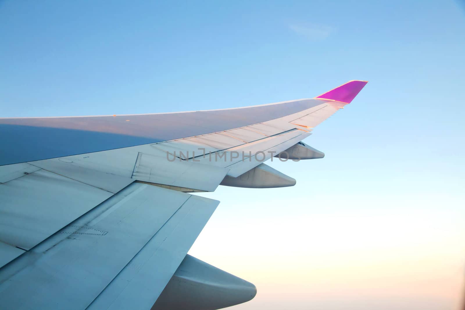 Sunrise with Airplanes wing from its windows with cloudscape