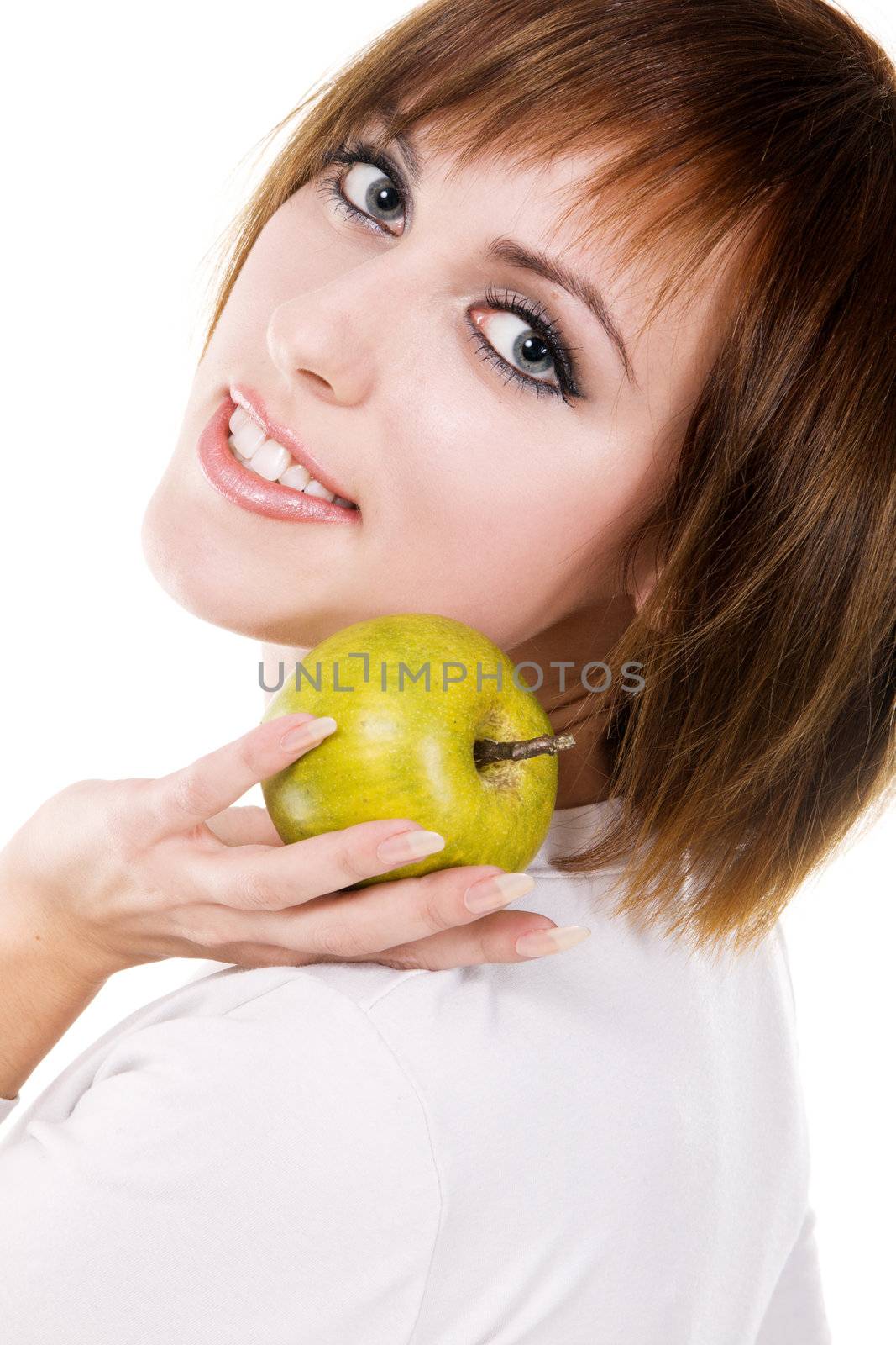 Portrait of a young beautiful woman with a green apple against white background 