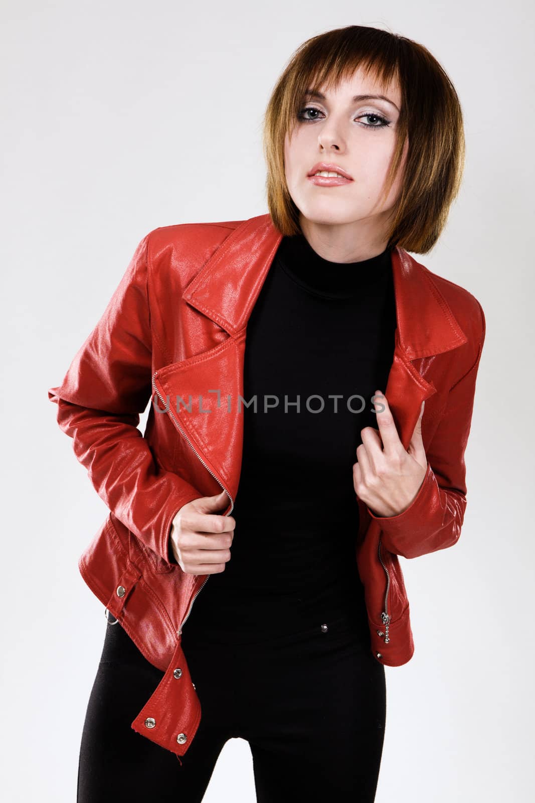 Studio portrait of a beautiful model in red leather jacket 