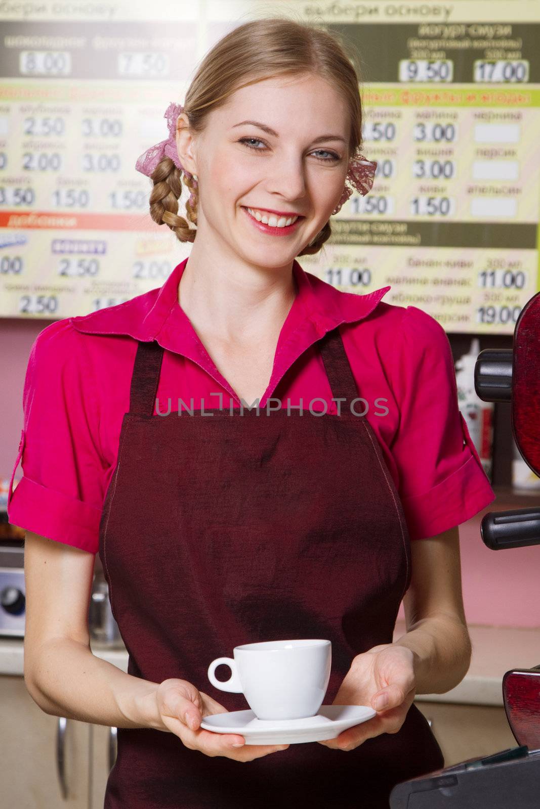 Friendly waitress making coffee at coffee machine