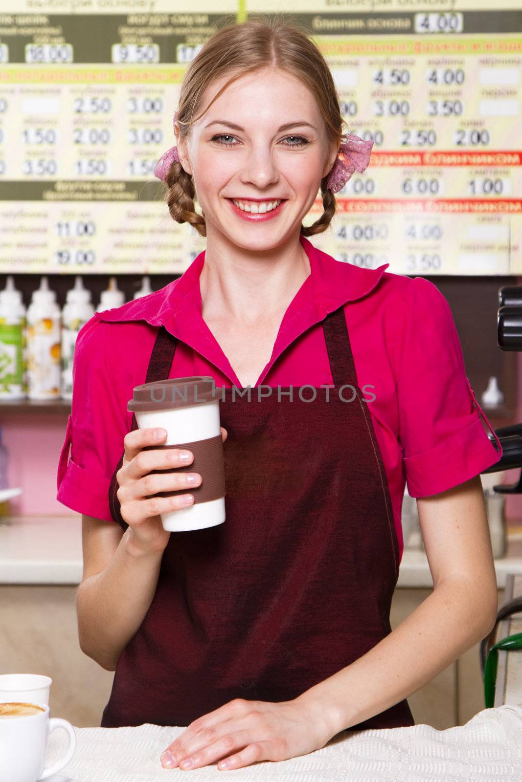 Friendly waitress making coffee at coffee machine