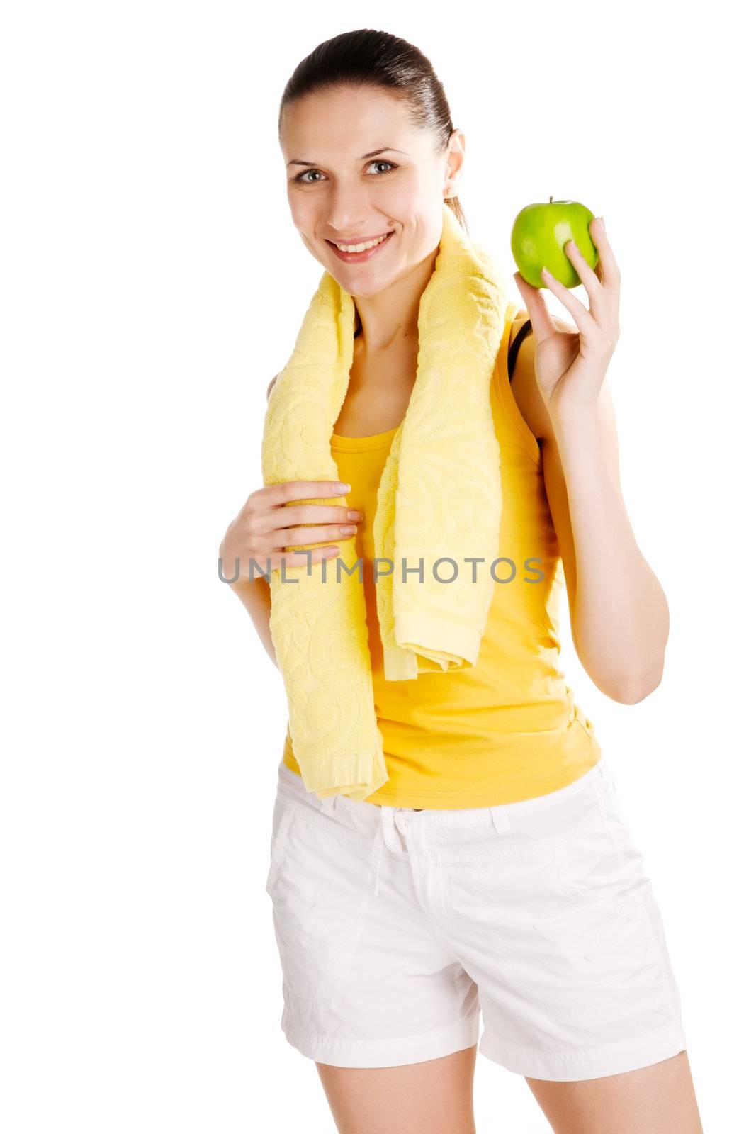 Beautiful young girl in sports outfit holding an apple, white background