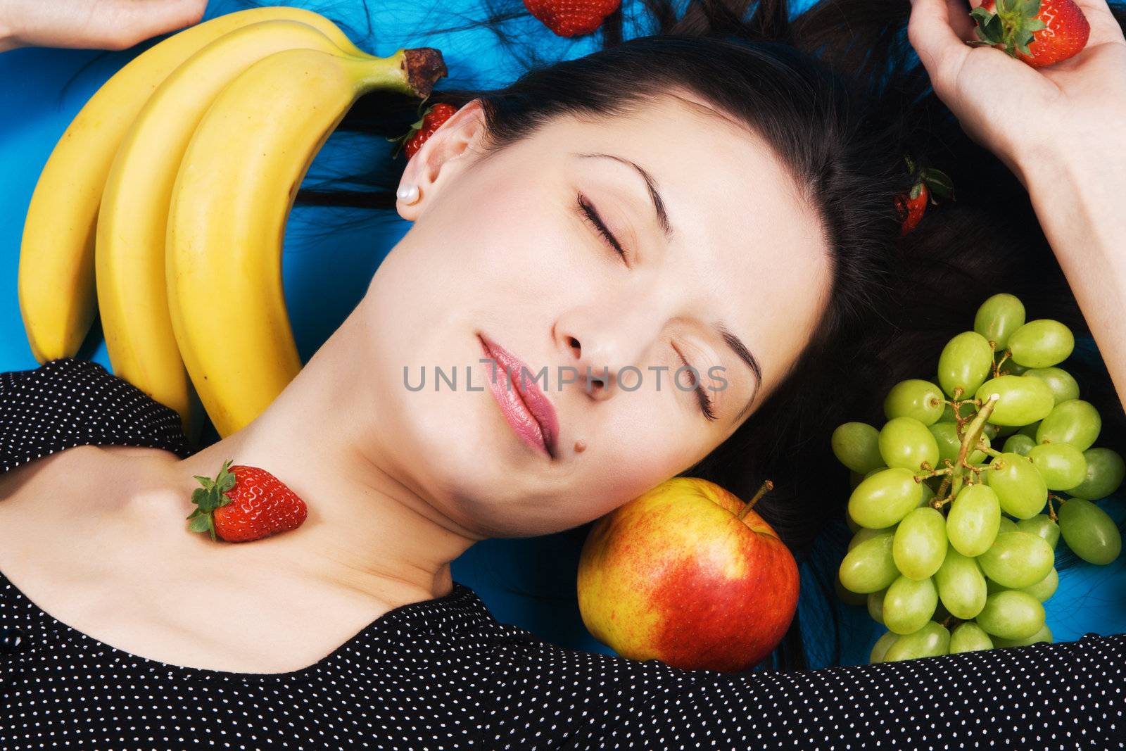 Beautiful young woman with a bunch of fruits by Gdolgikh