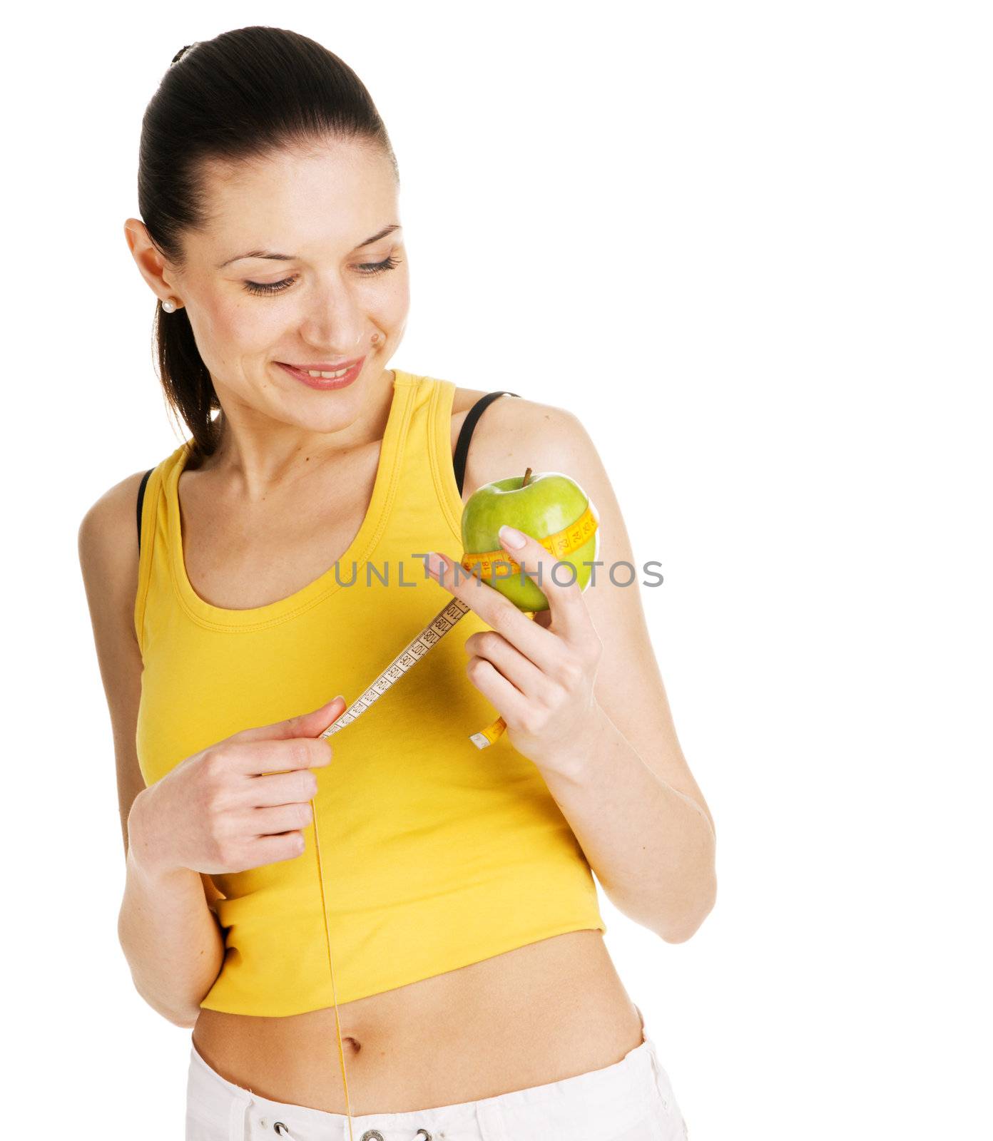 Beautiful slim woman holding a green apple, white background