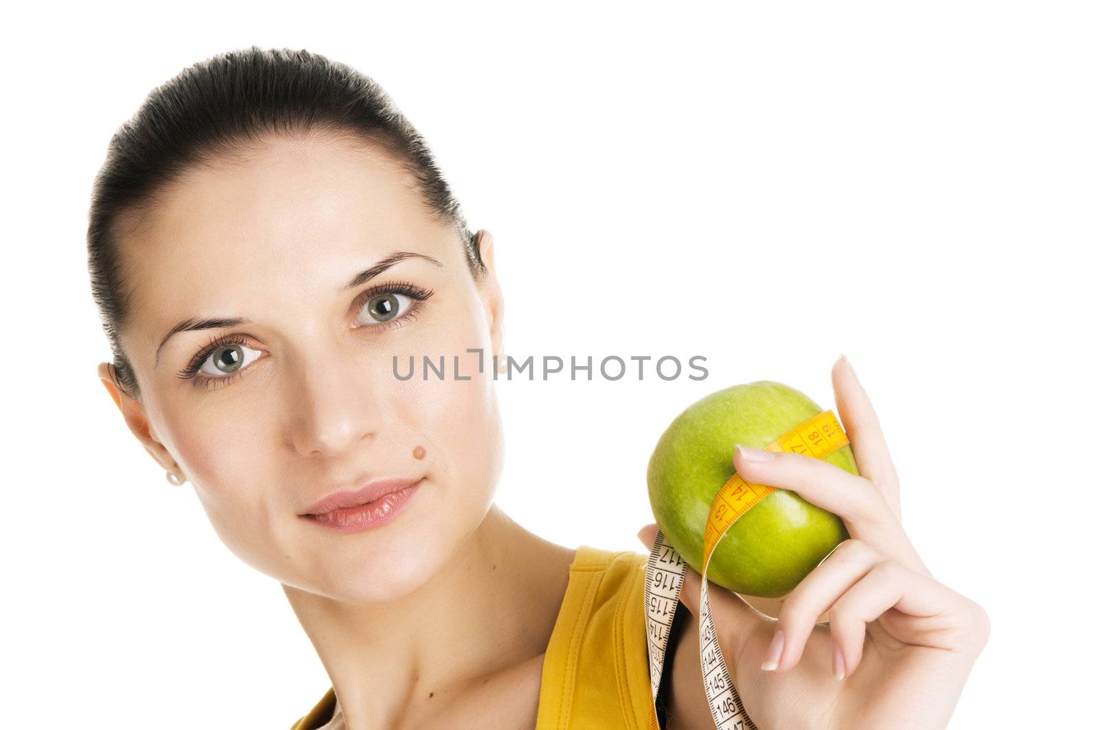 Beautiful slim woman holding a green apple, white background