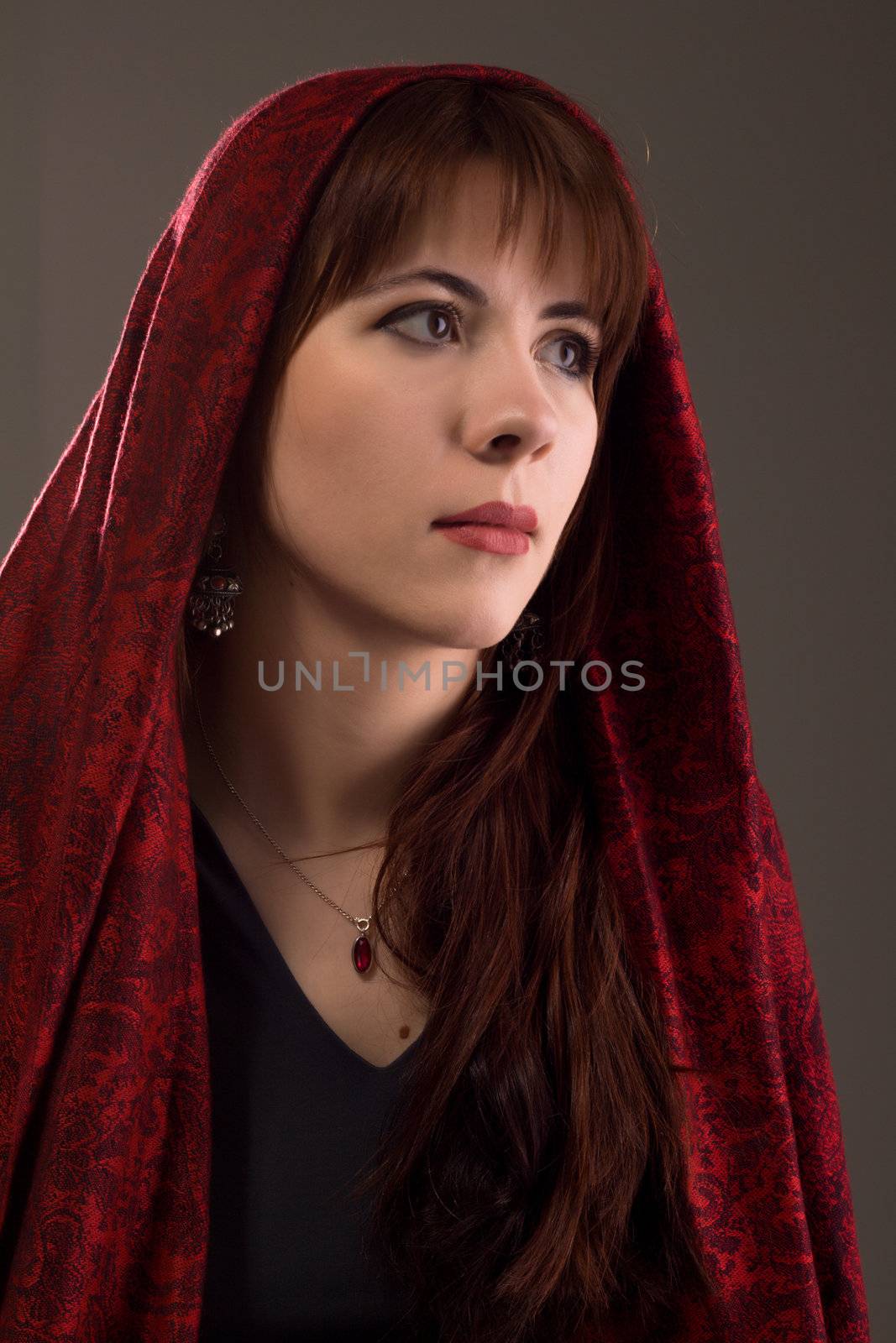 Beautiful young woman studio portrait by Gdolgikh