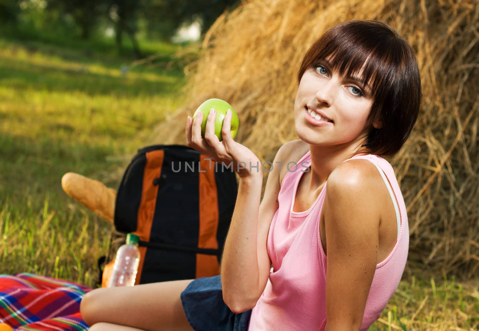 Lovely girl having a rest on picnic at countryside