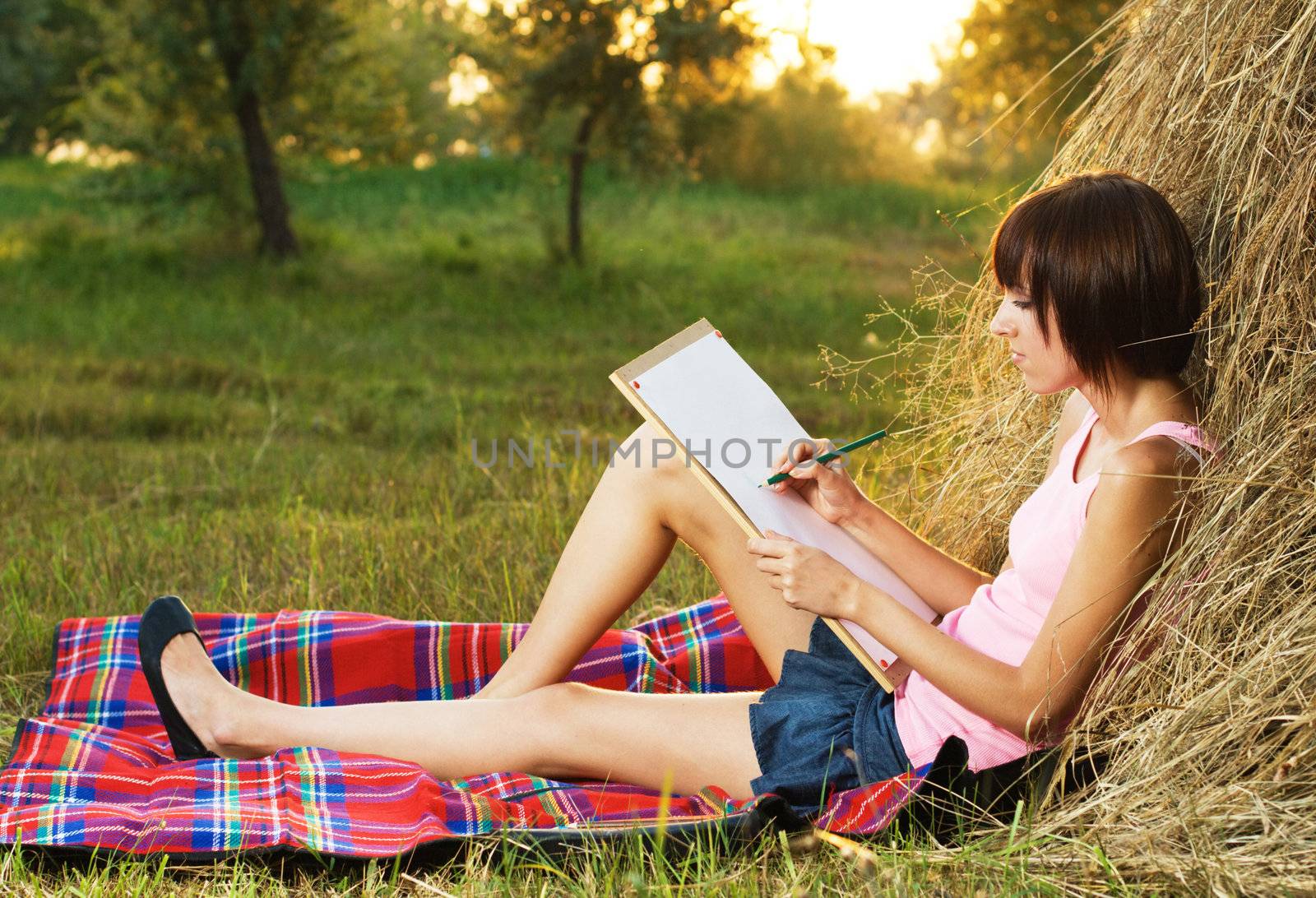 Lovely girl drawing in the park by Gdolgikh