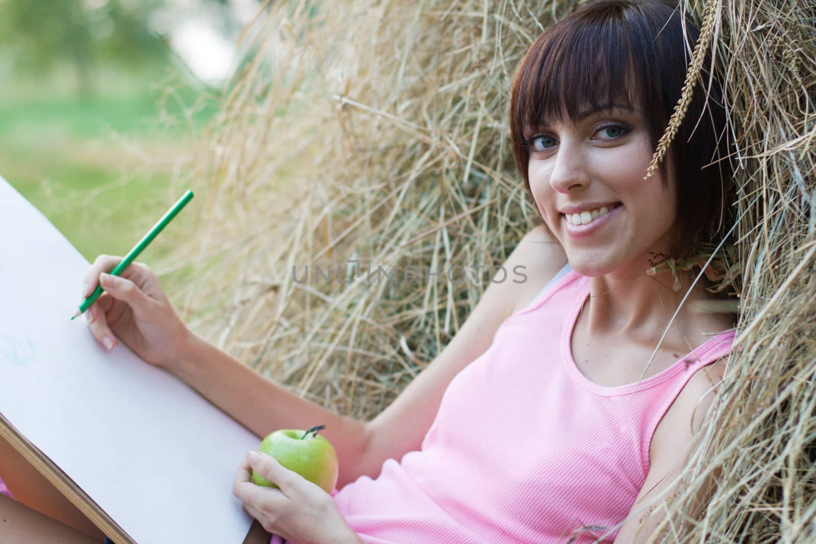 Lovely girl drawing in the park by Gdolgikh