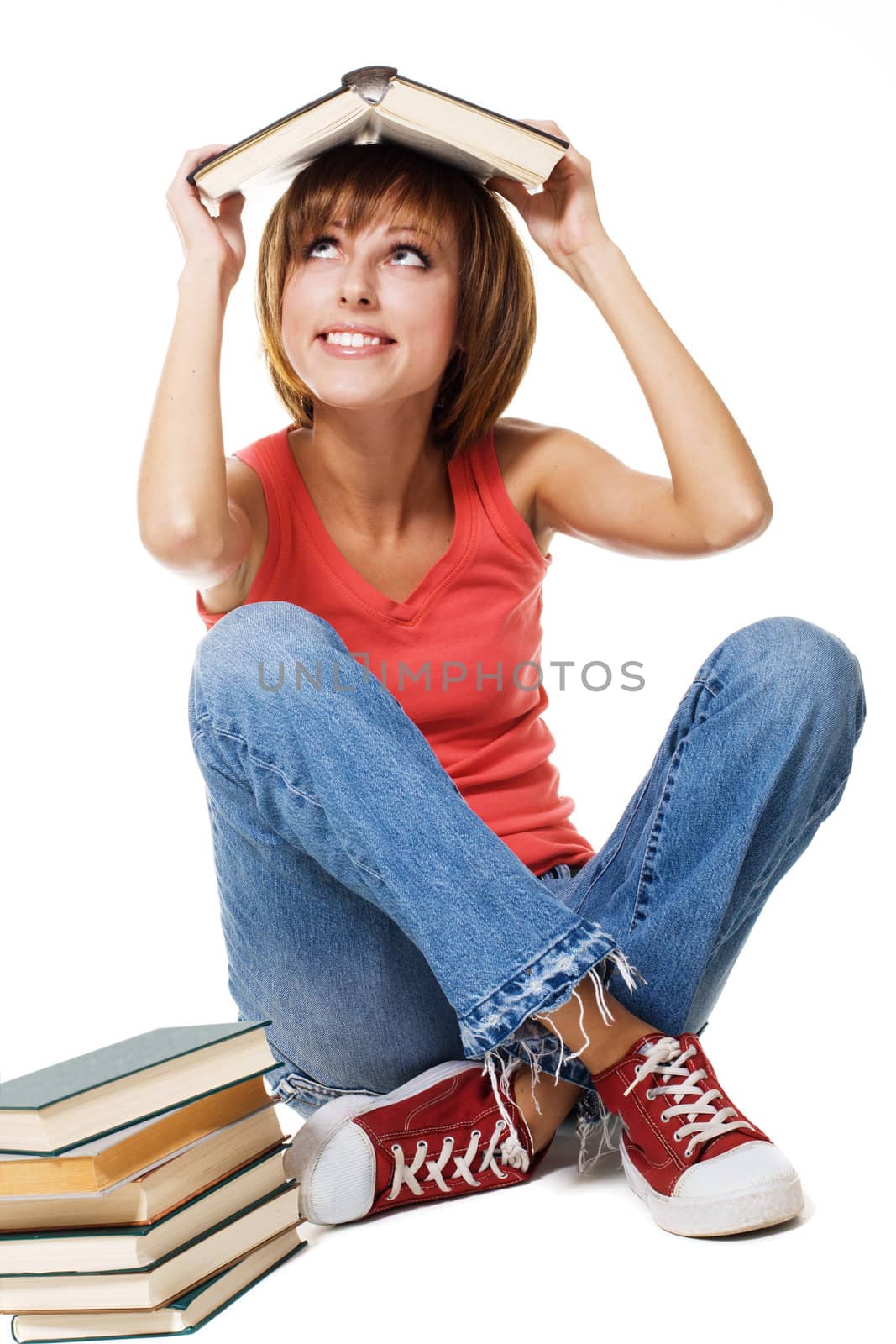 Lovely student girl with a stack of books, white background