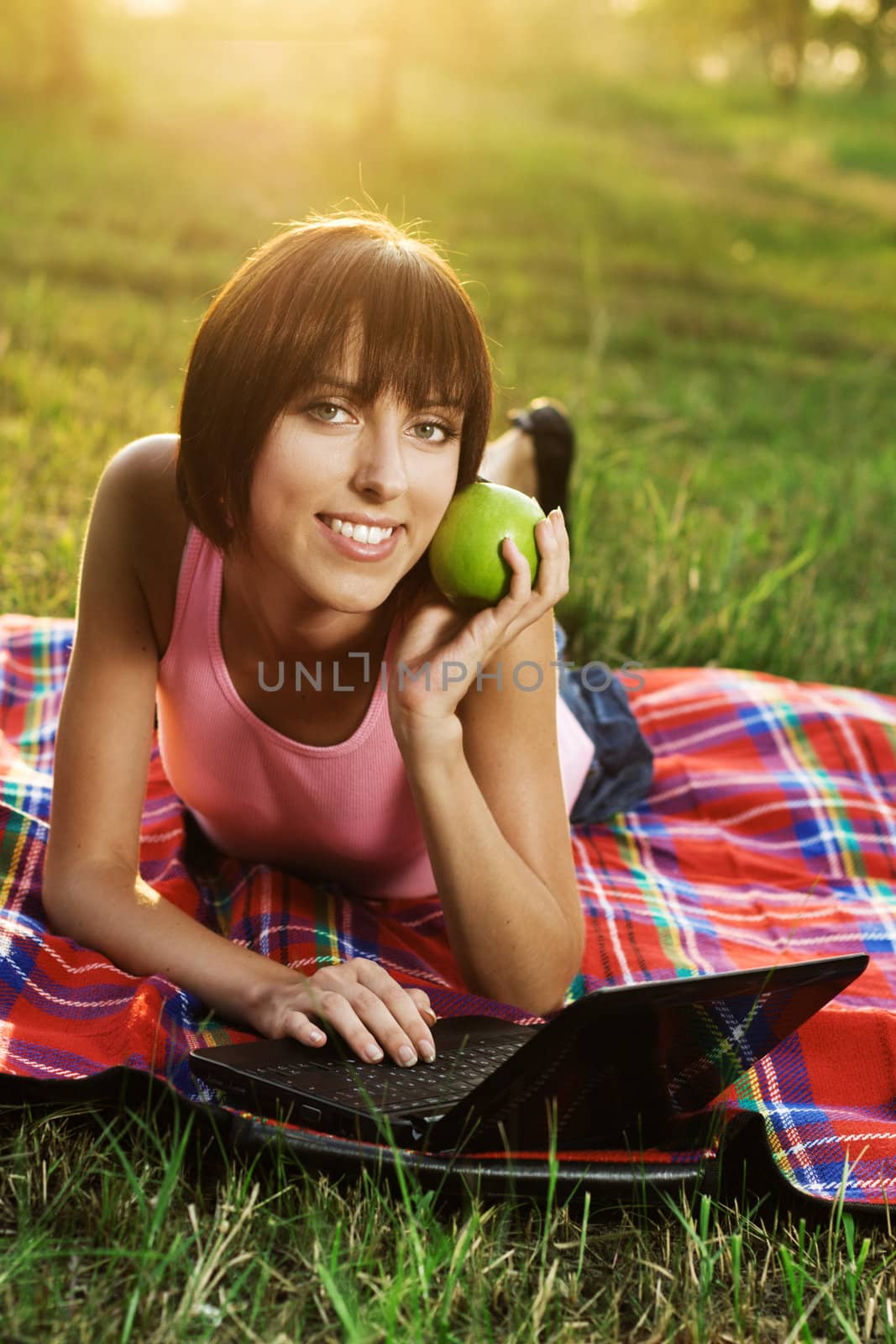 Lovely girl with laptop on picnic by Gdolgikh