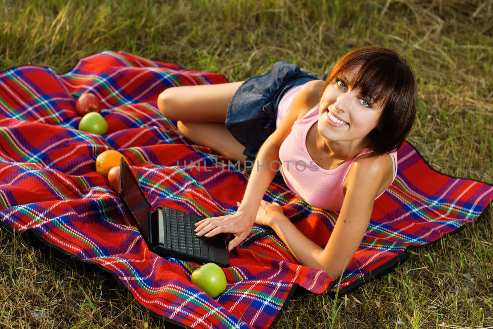 Lovely girl having a rest on picnic in the park 