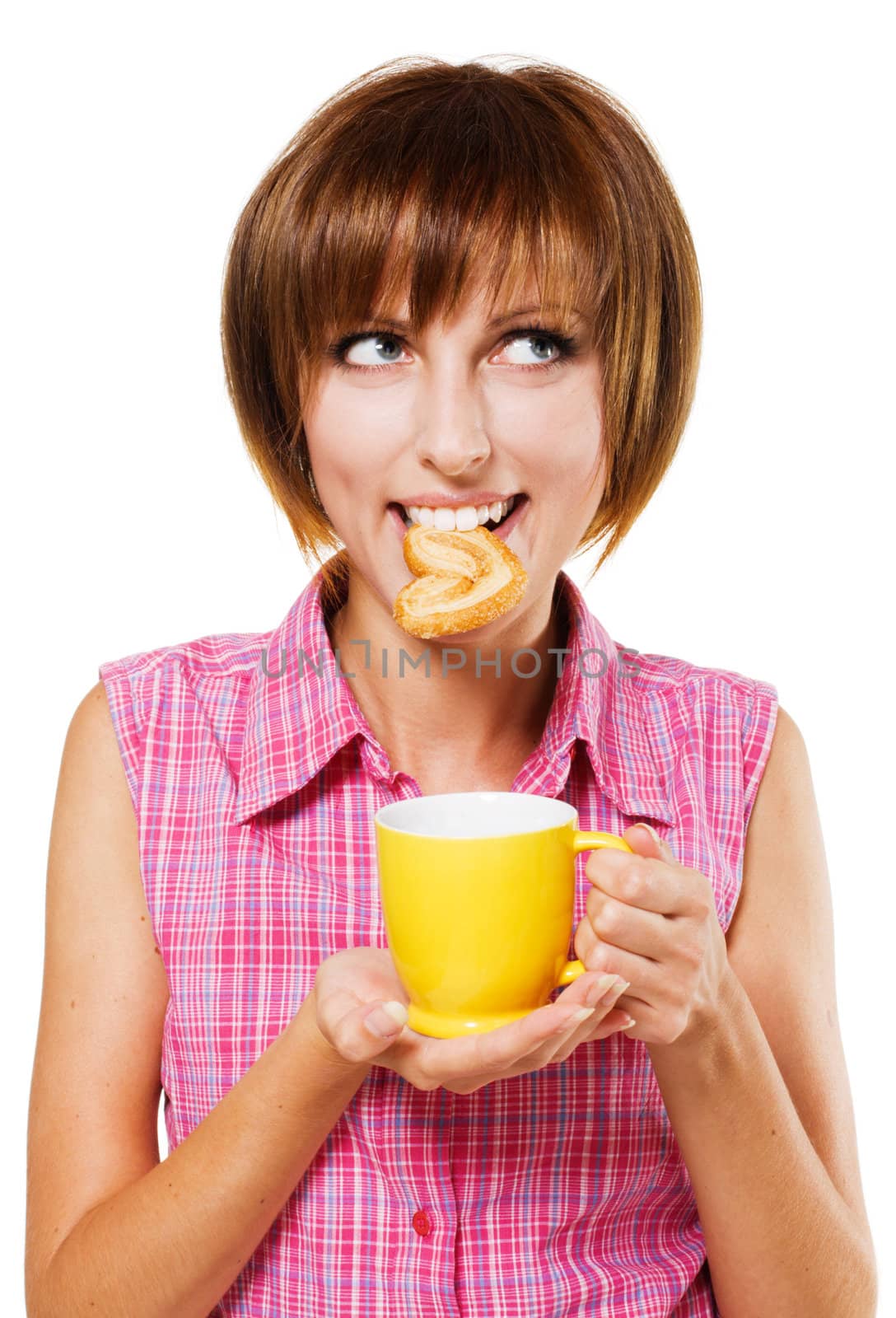 Cute girl with a tea cup biting a pretzel, white background 