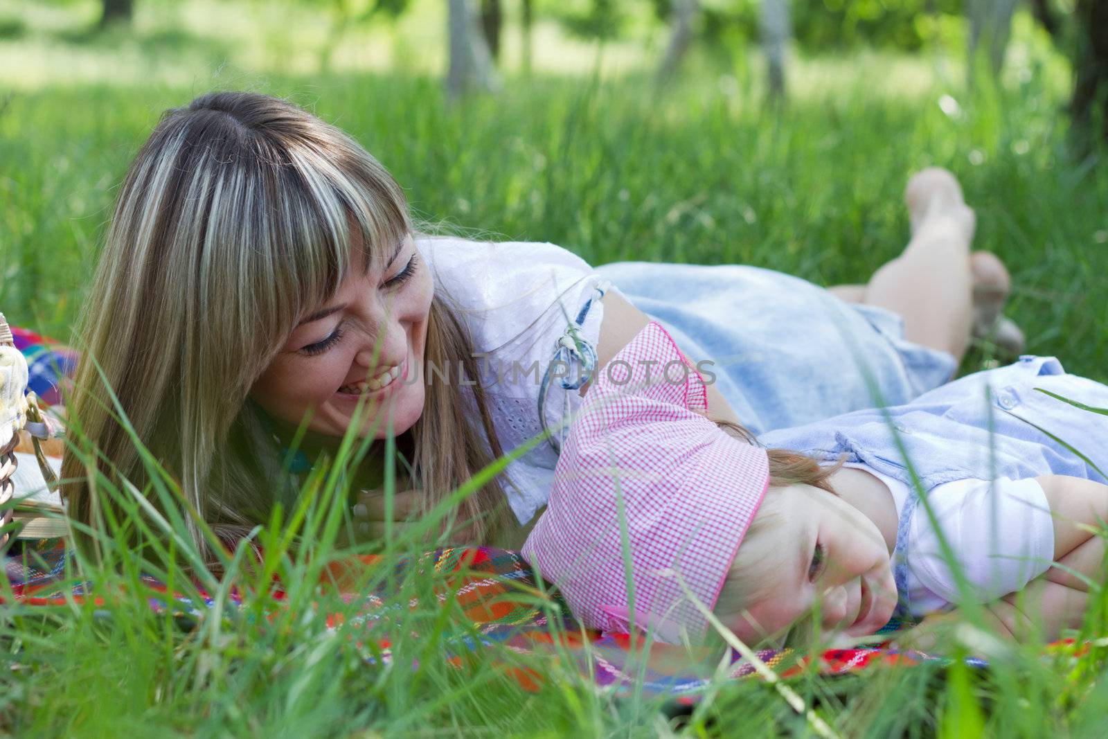 Cheerful mother with her daughter outdoor portrait
