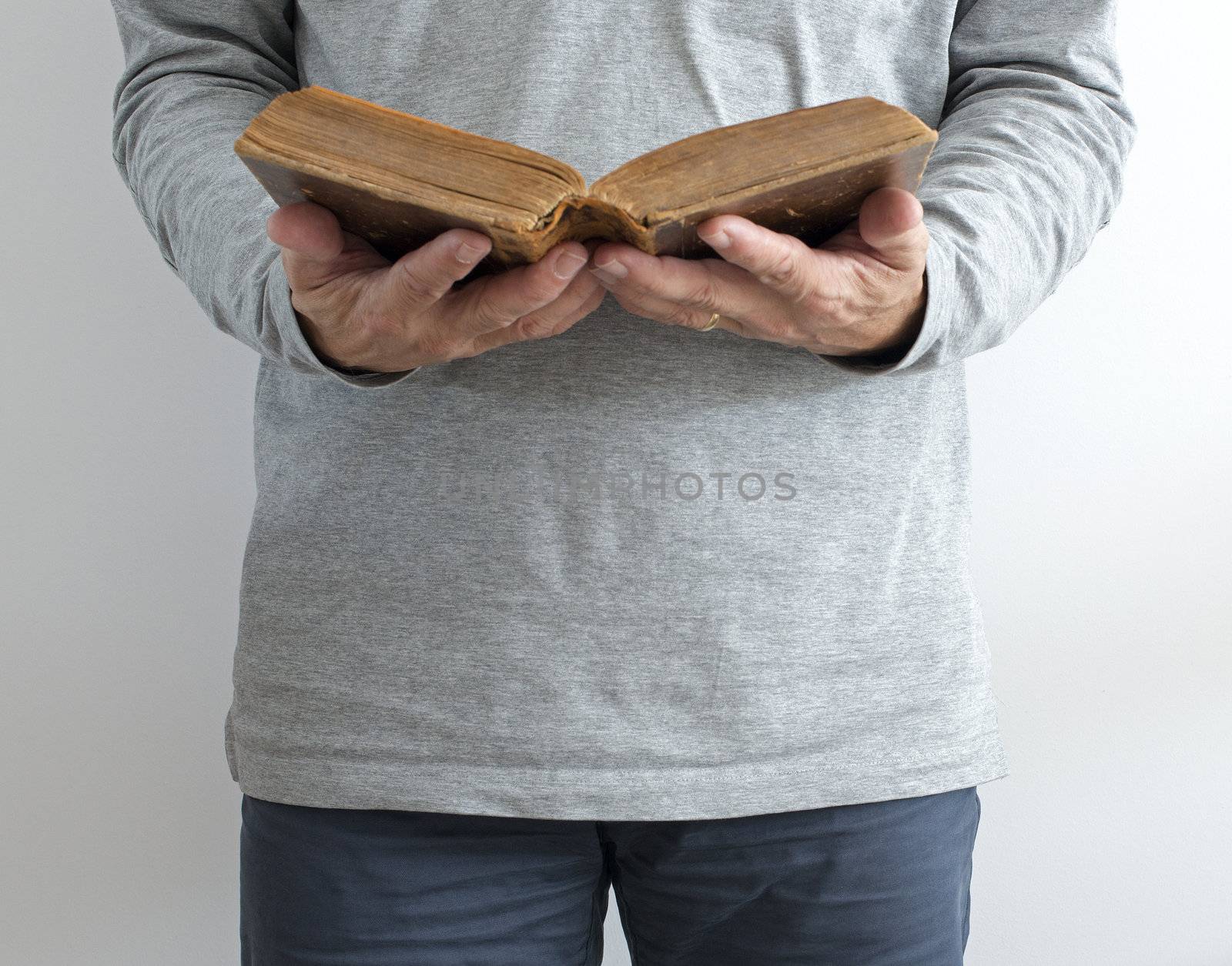 man reading old bible while standing