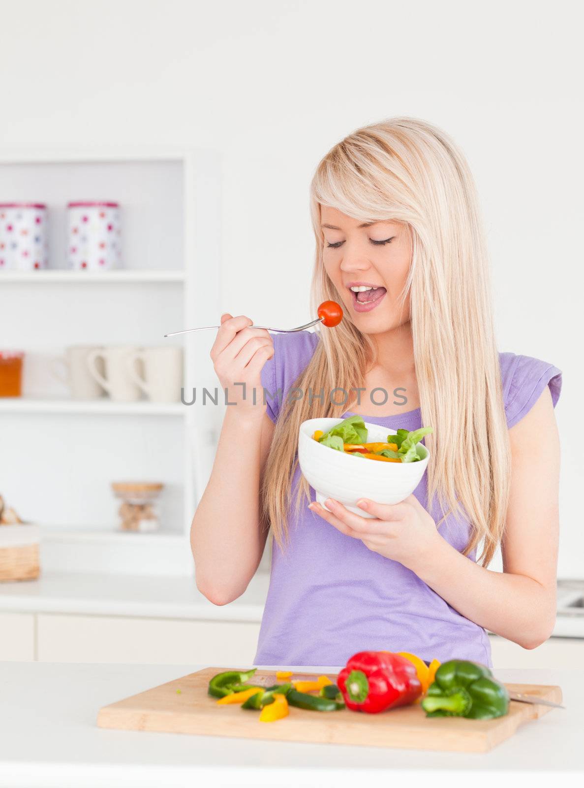Good looking female eating her salad by Wavebreakmedia