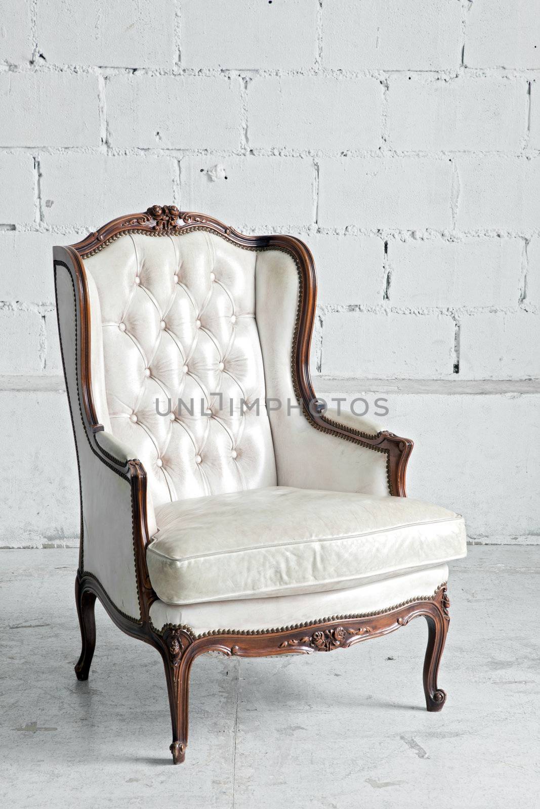 White genuine leather classical style sofa in vintage room