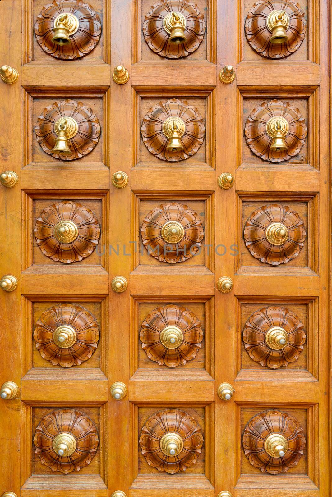 Wooden temple door with bells in Hindu temple 