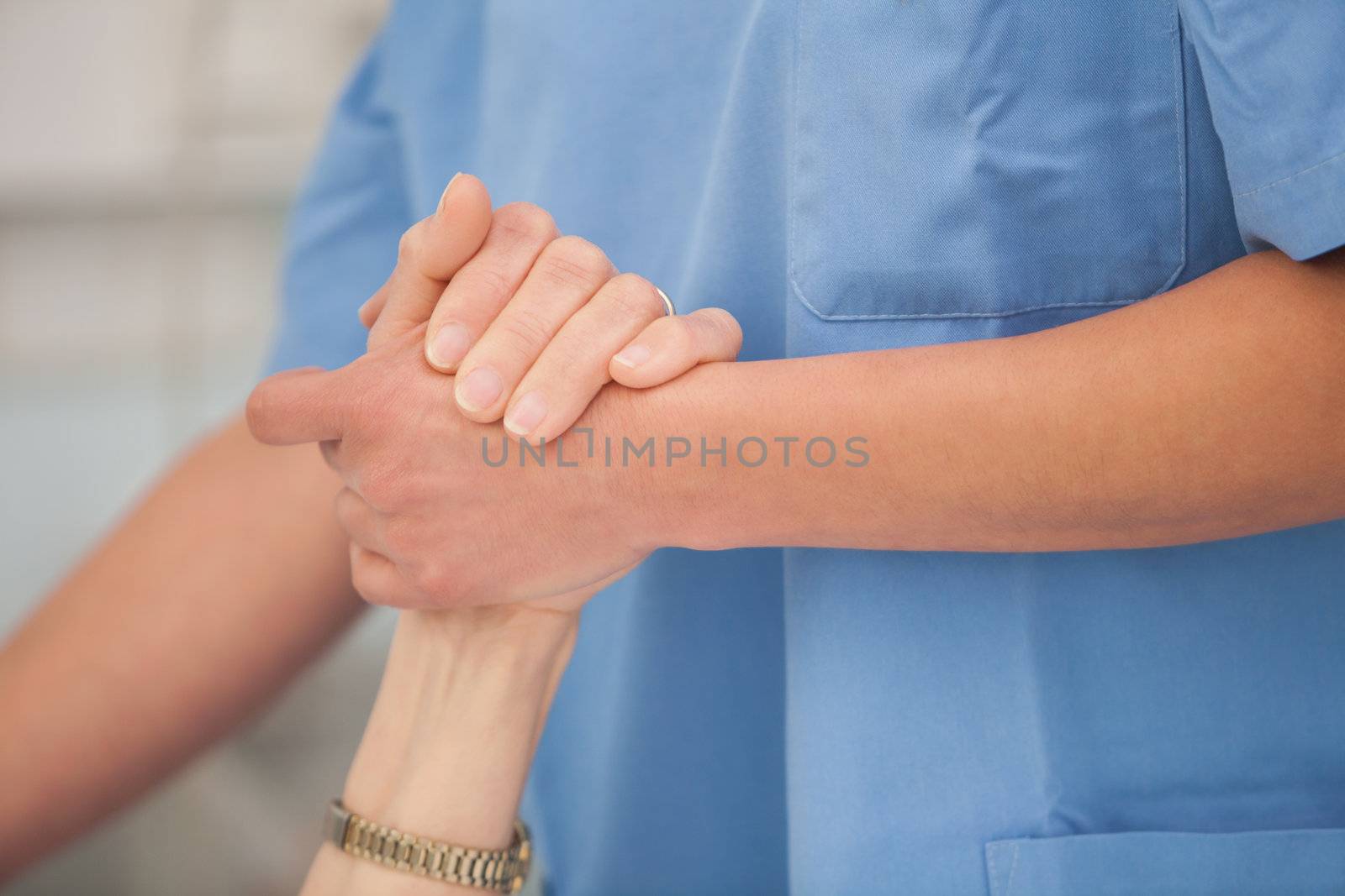 Nurse holding the hands and take care of the elderly woman