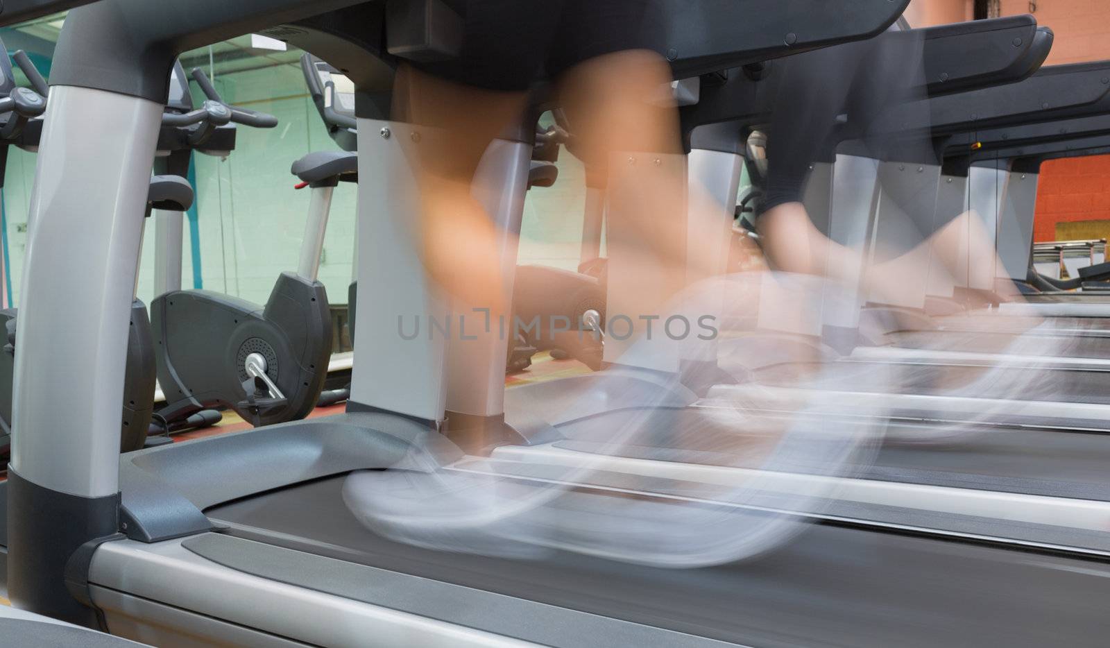 People jogging on a treadmill by Wavebreakmedia