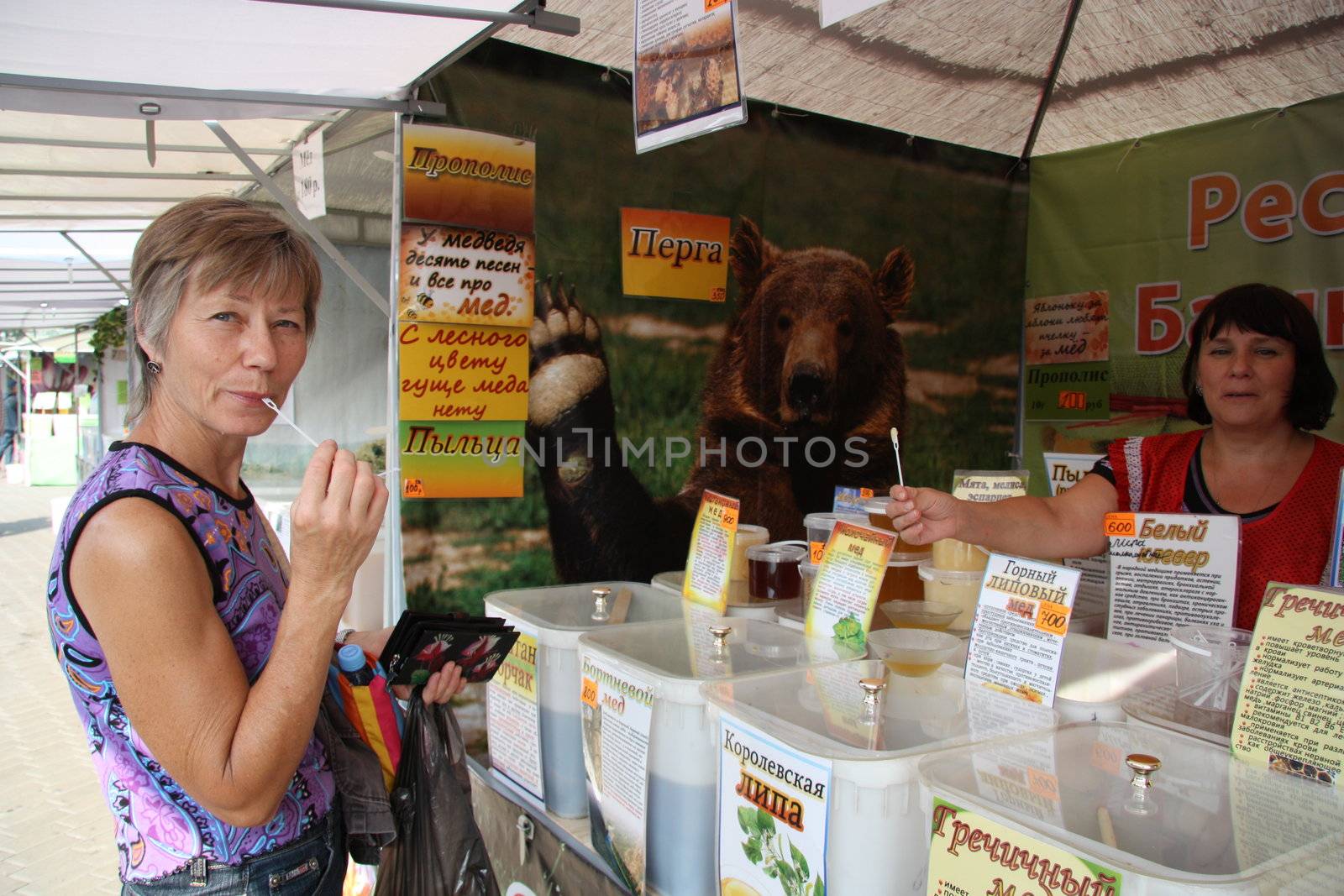 Woman Customer buying honey at the market, Moscow, Russia