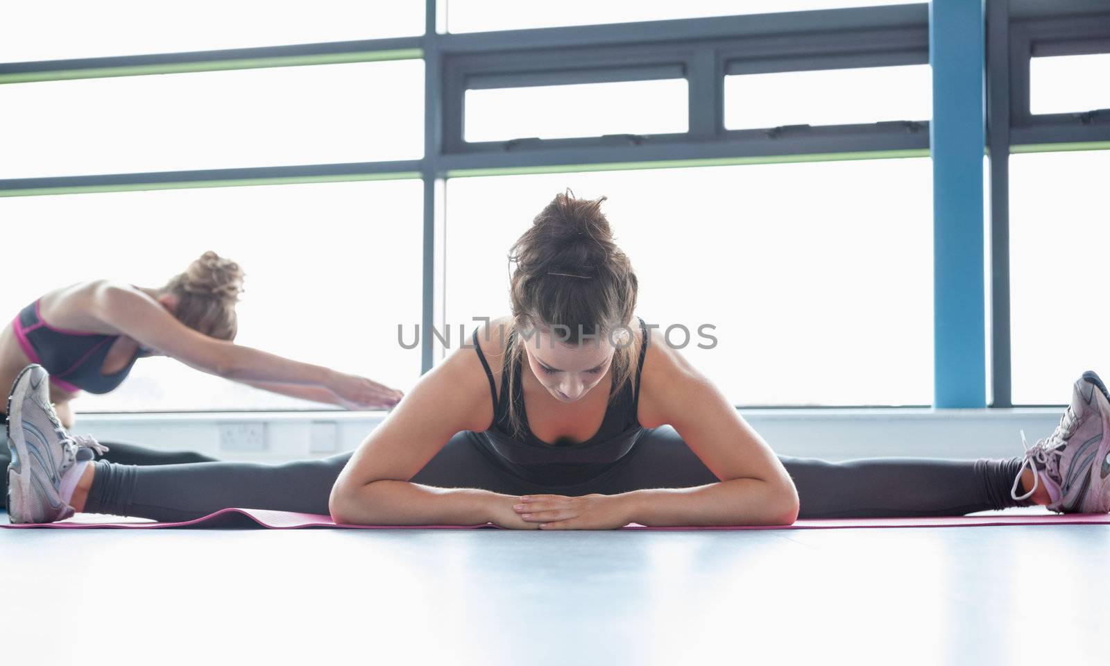 Woman stretching her legs in a gym