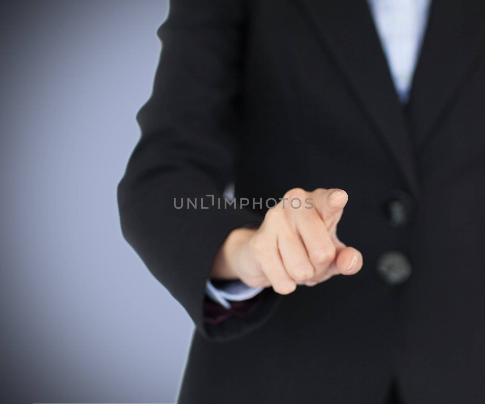 Businesswoman pointing at the camera