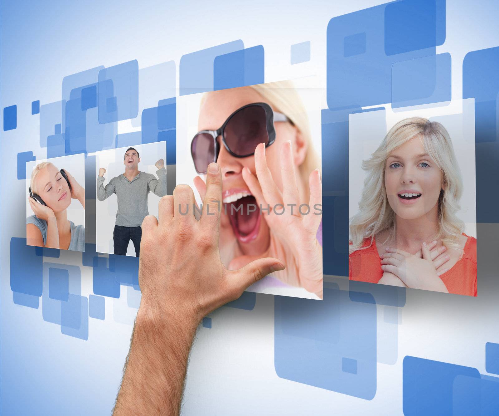 Male hand selecting one of four photos on digital blue wall