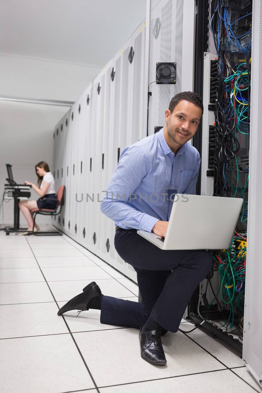 Two people doing data storage with laptops