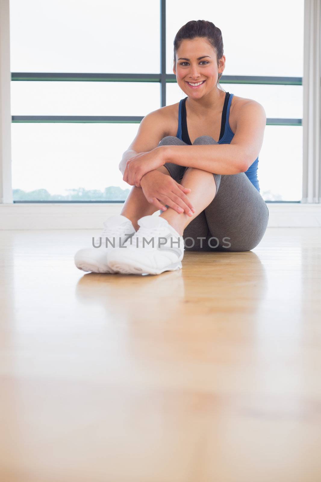 Woman sitting in fitness studio by Wavebreakmedia