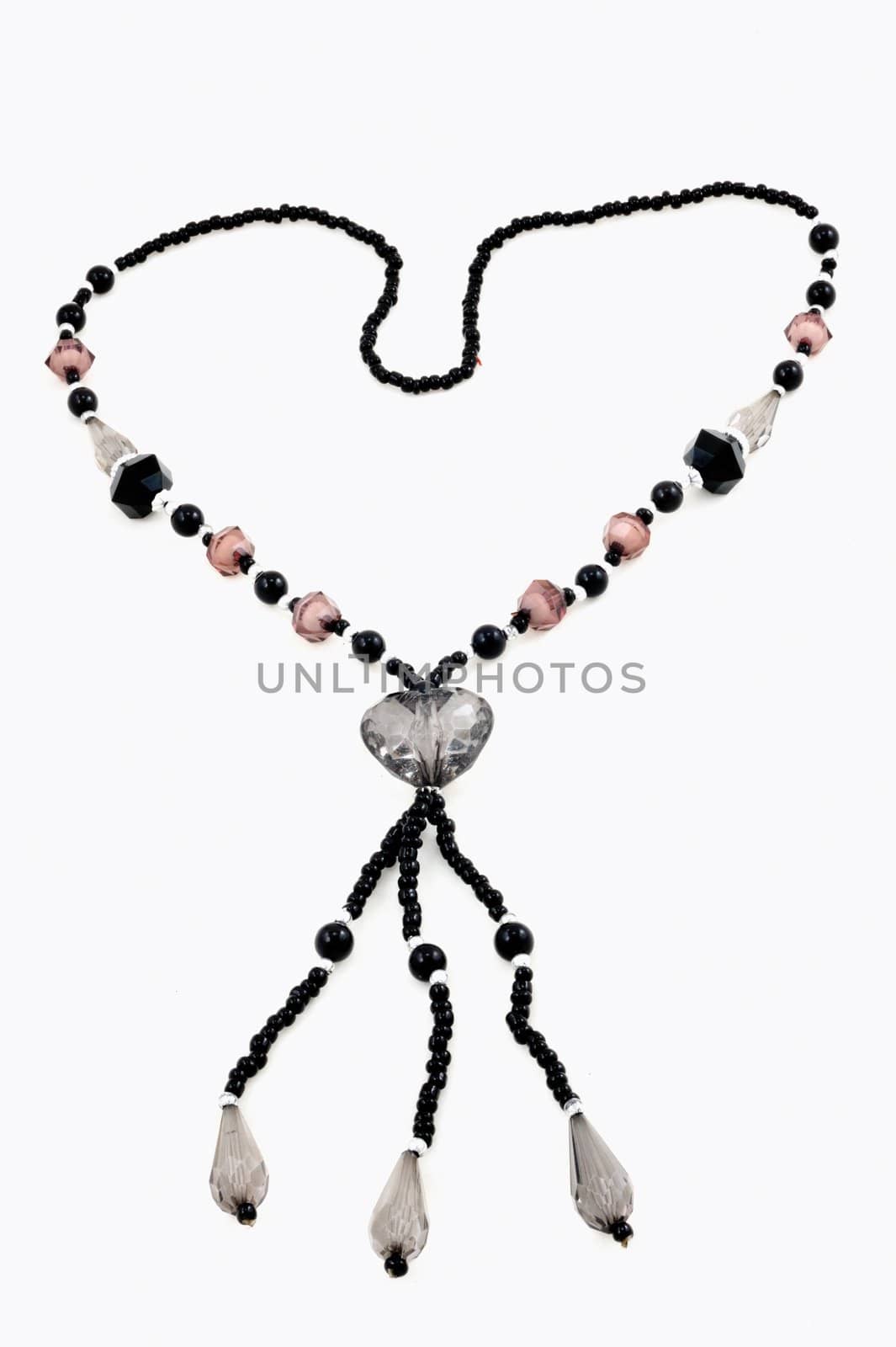 The necklace with black and manycollor stone in love on isolated.
