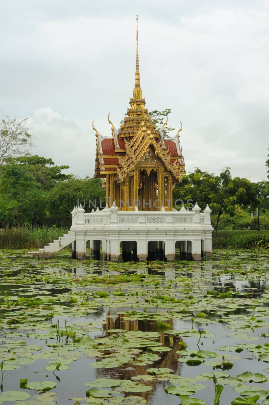 Thai pavilion in lotus pond at partly cloudy , Suan Luang Rama IX Thailand.
