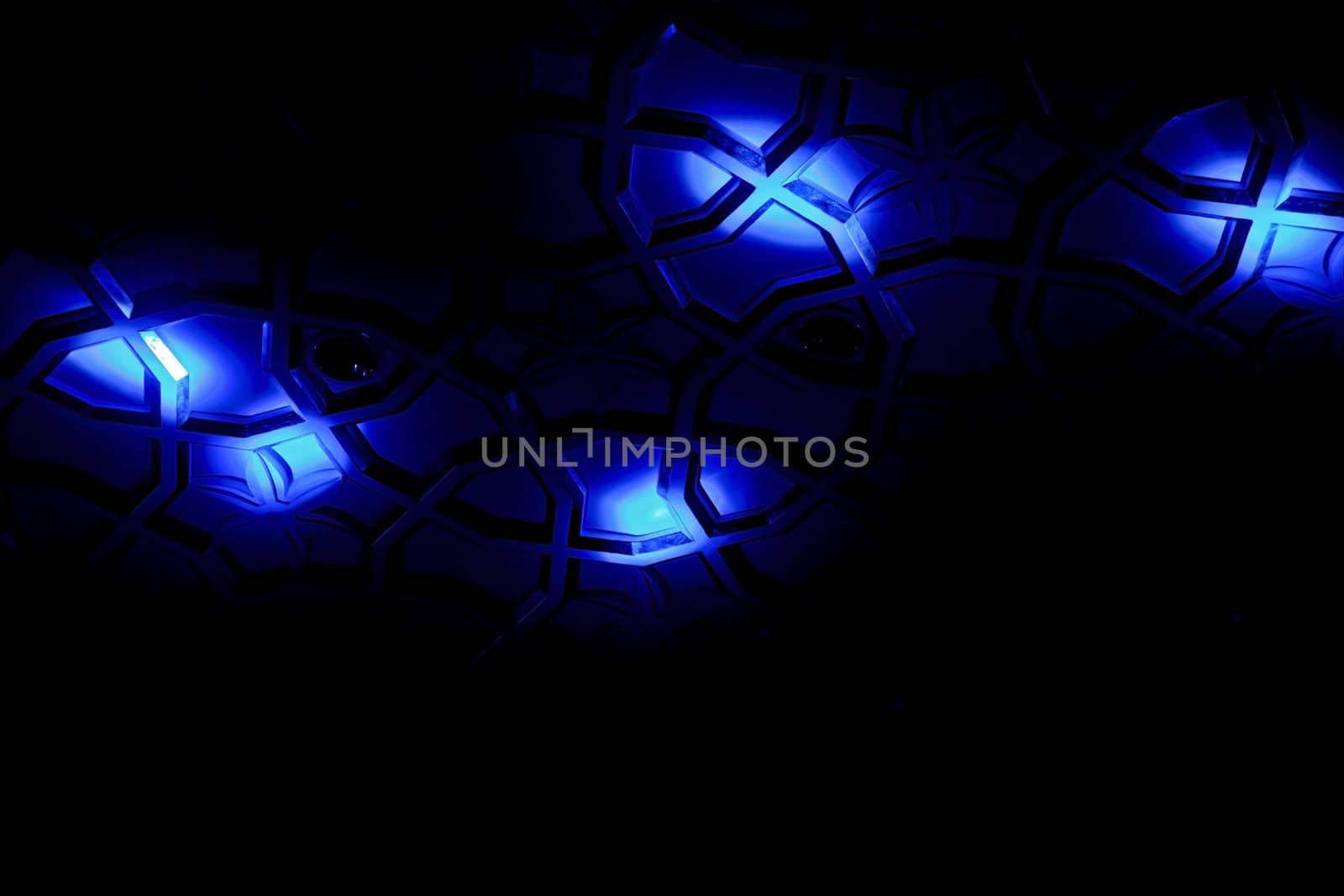 Generic shot of blue spot lights falling on a patterned surface creating shapes, angles, lines and form. Shot location was Goa India