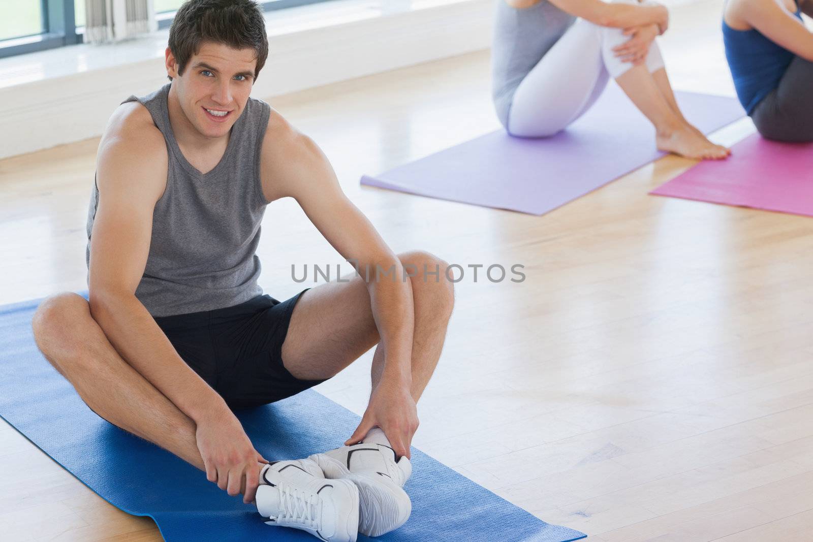 Man at yoga class in fitness studio