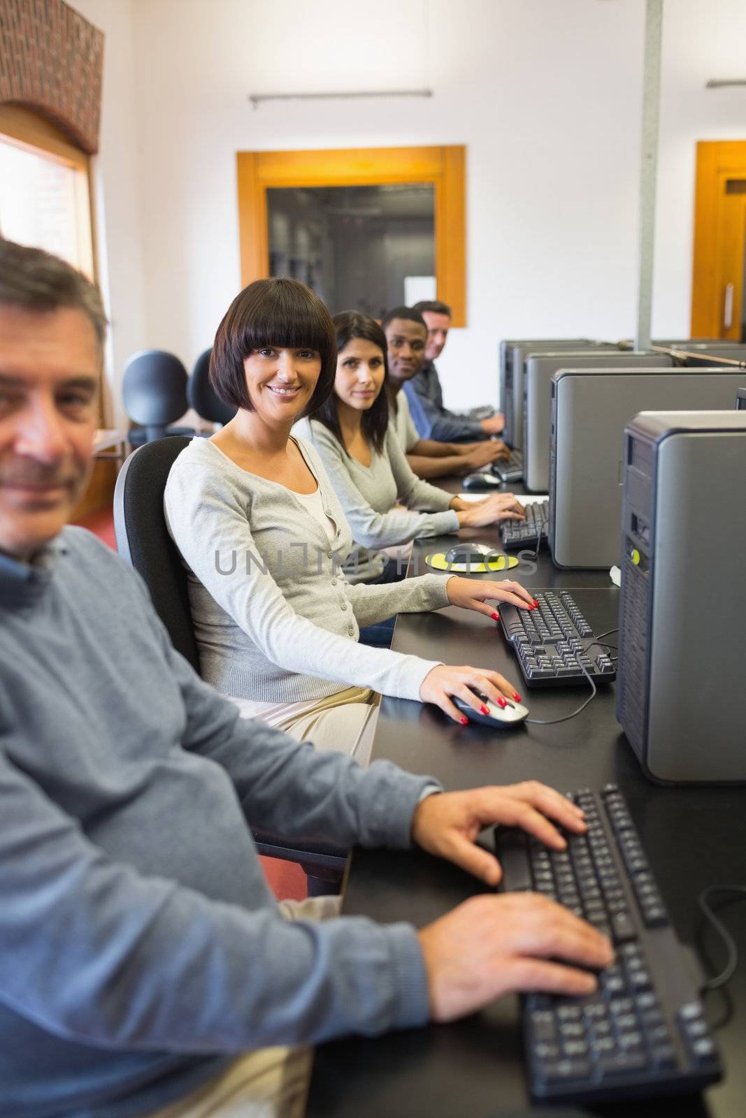 Smiling computer class in college