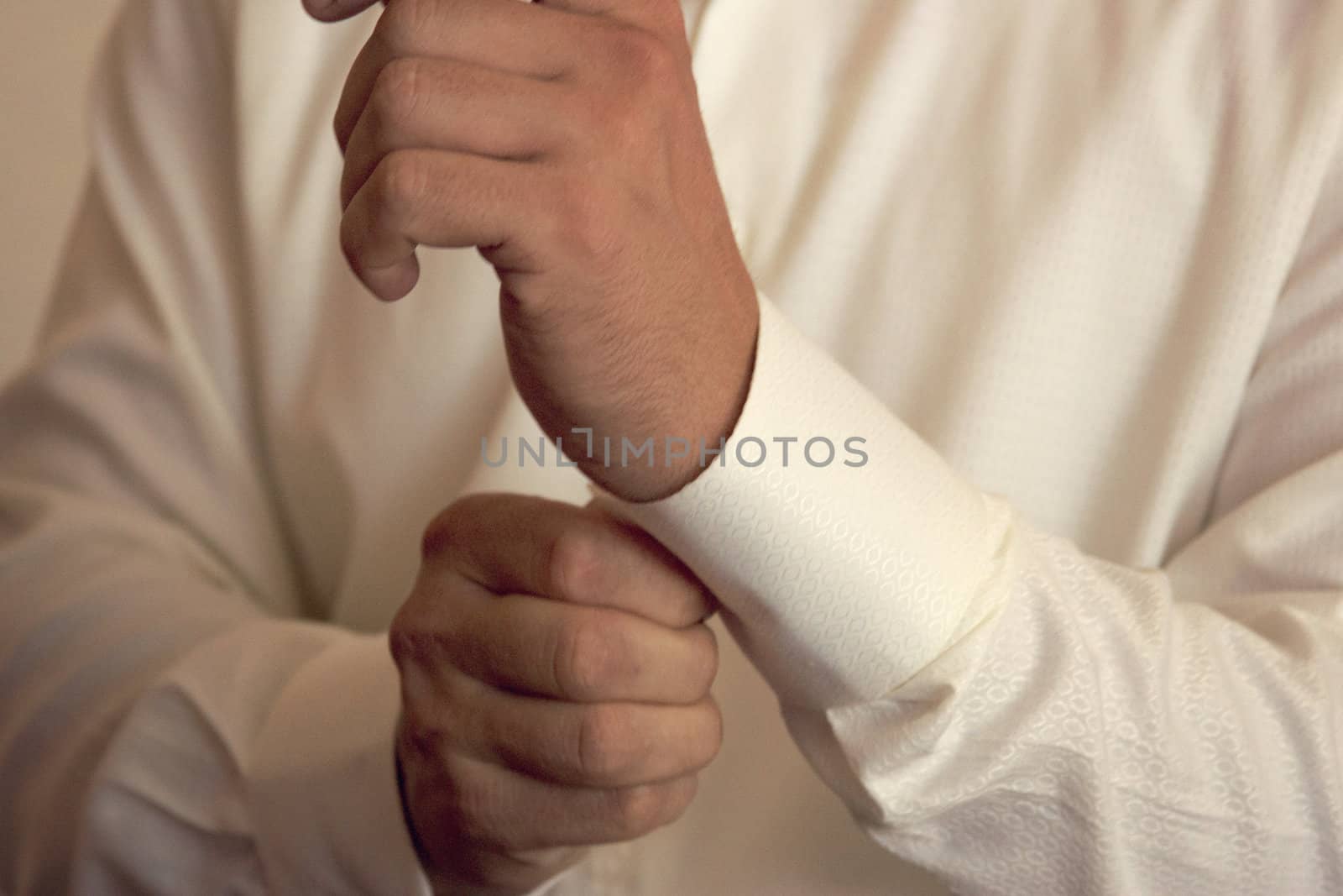 Close-up of elegance man hands with ring, necktie and cufflink