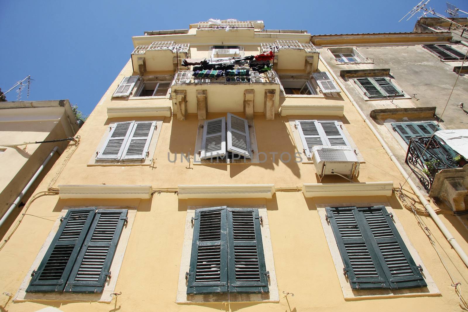 Old house in Corfu with wooden windows and balcony