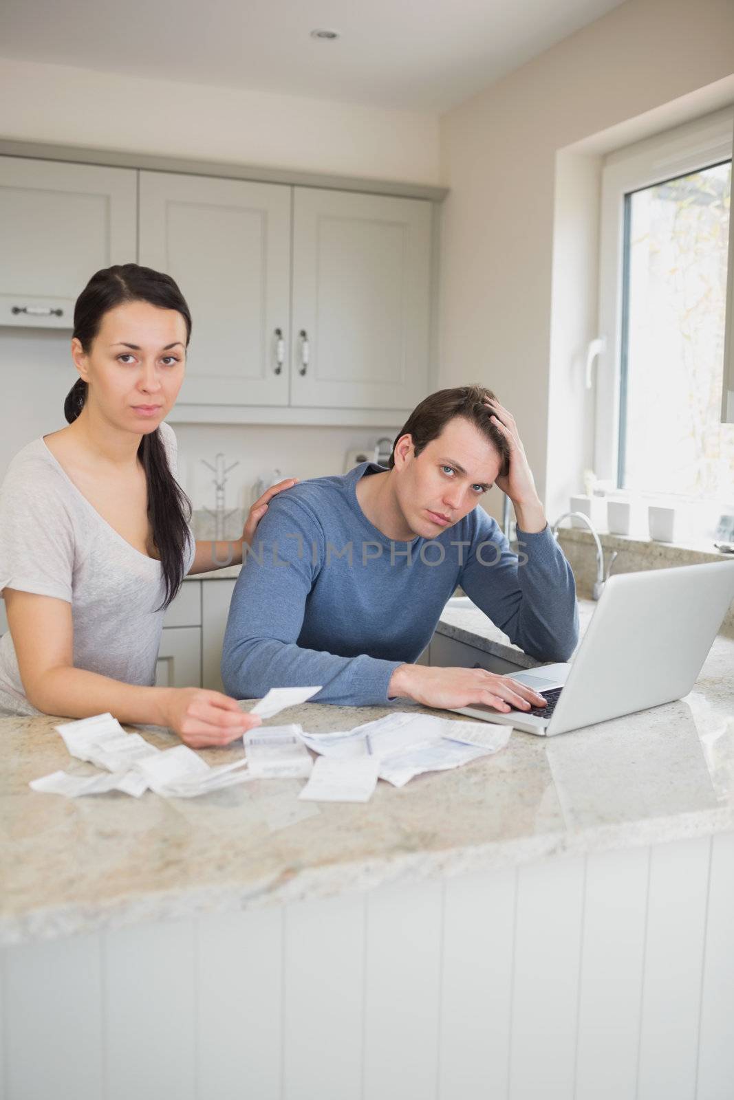 Couple calculating with the laptop by Wavebreakmedia