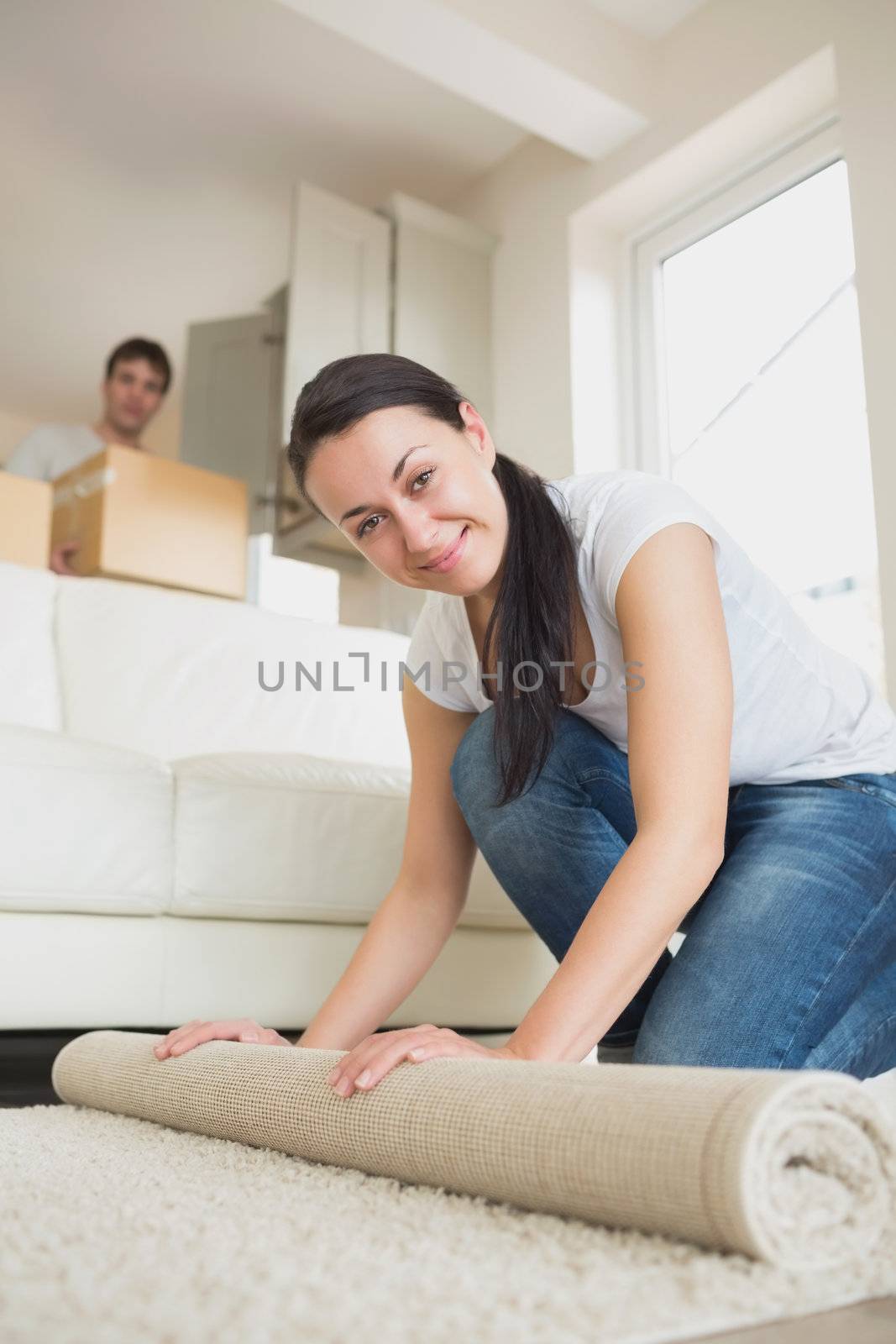 Two young people moving into the house and furnishing the living room
