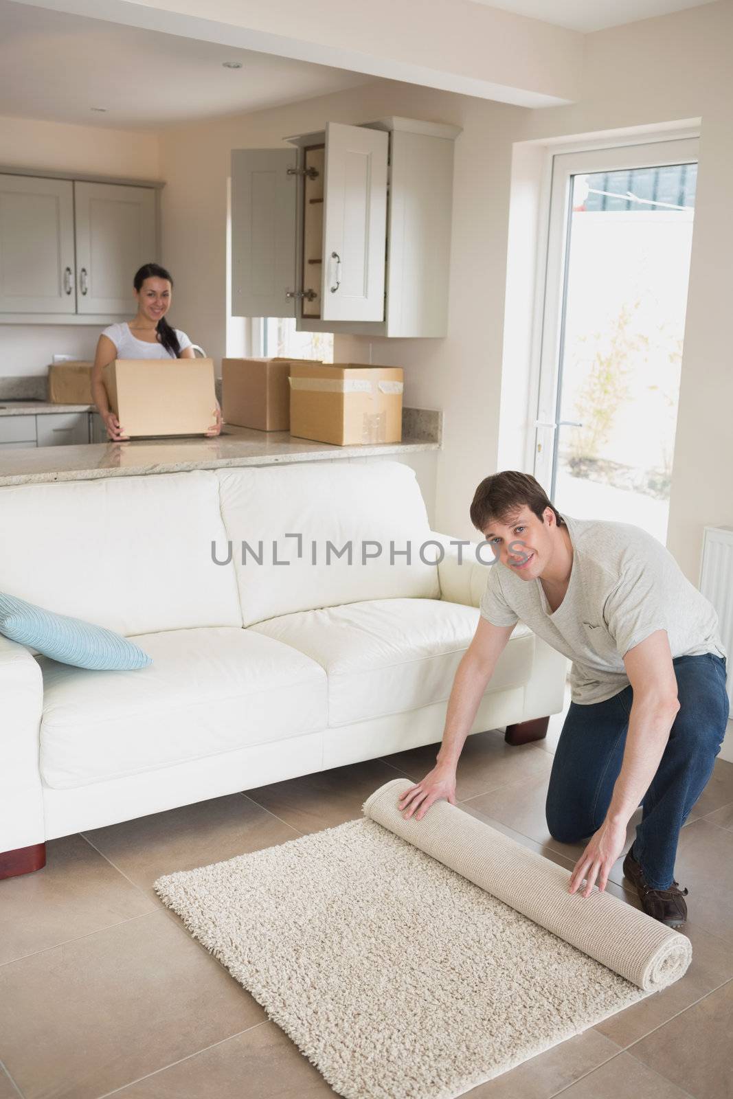 Young man and woman furnishing their kitchen and living room for a relocation