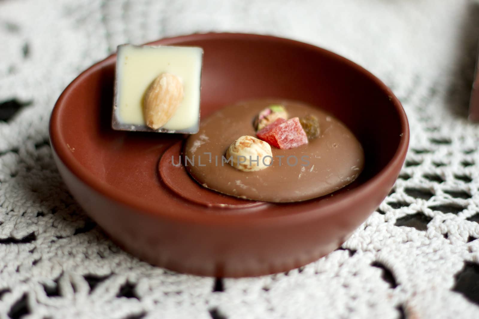 Sweets in brown saucer by victosha
