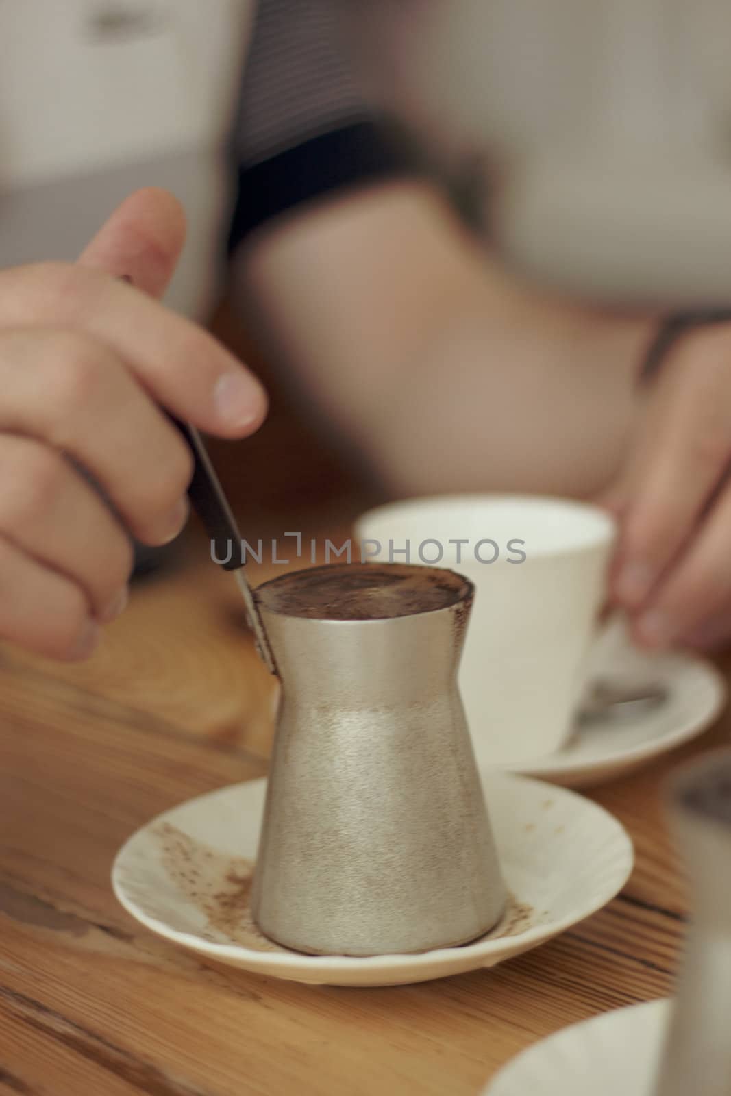 Hands of the man who brews coffee, cup of coffee